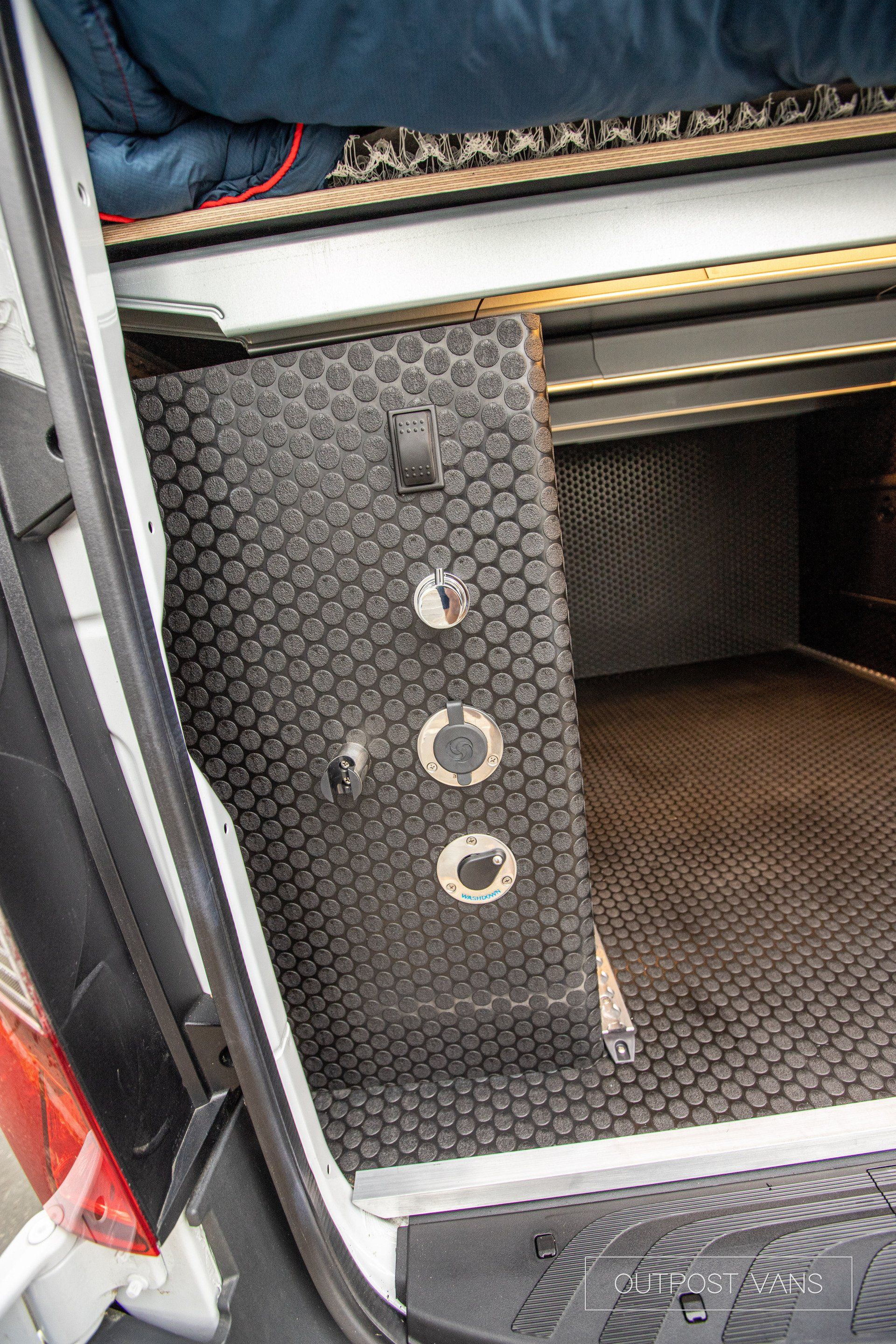 a suitcase is sitting in the back of a van .