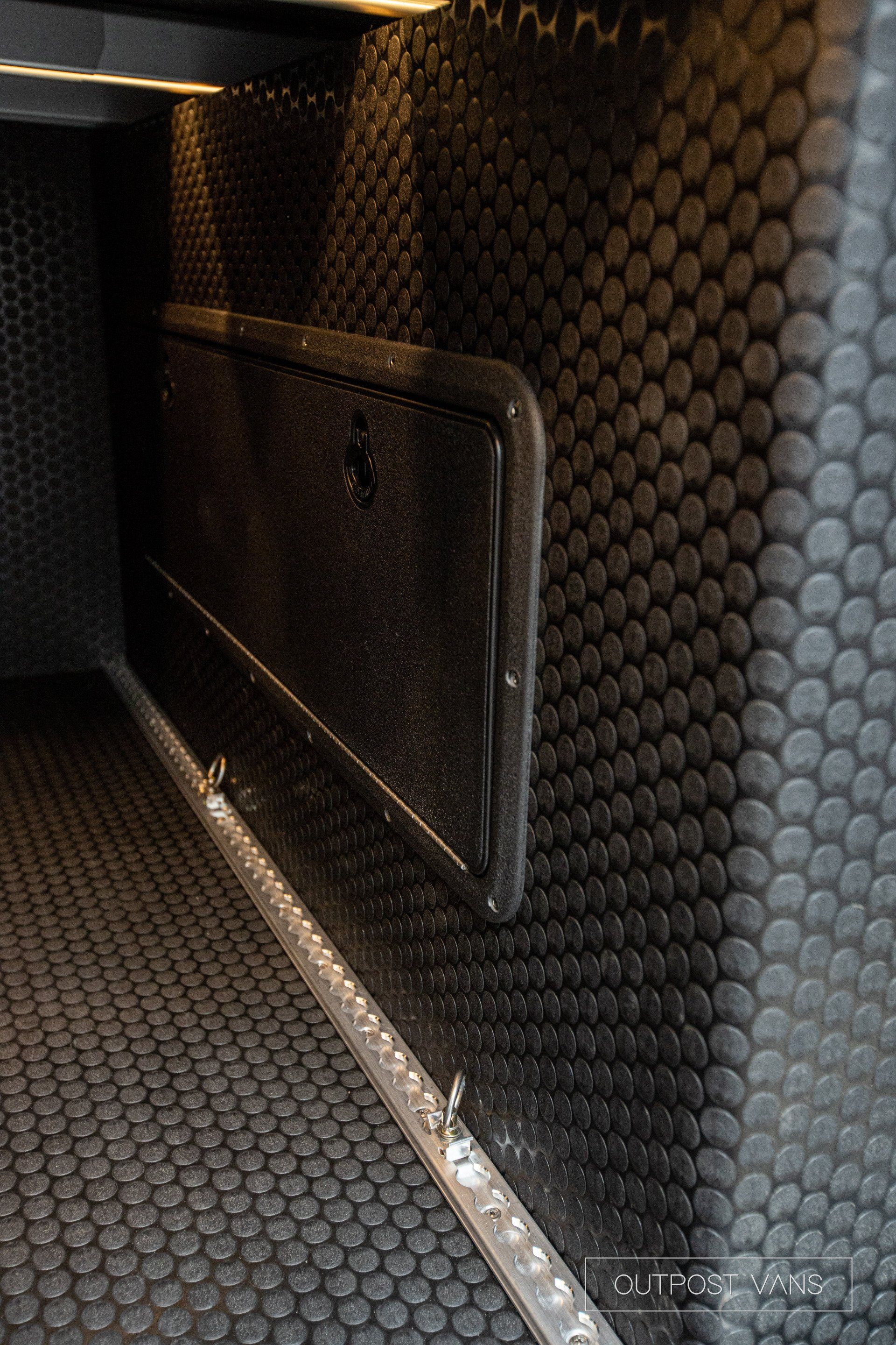 a close up of a door in a room with a rubber mat on the floor .