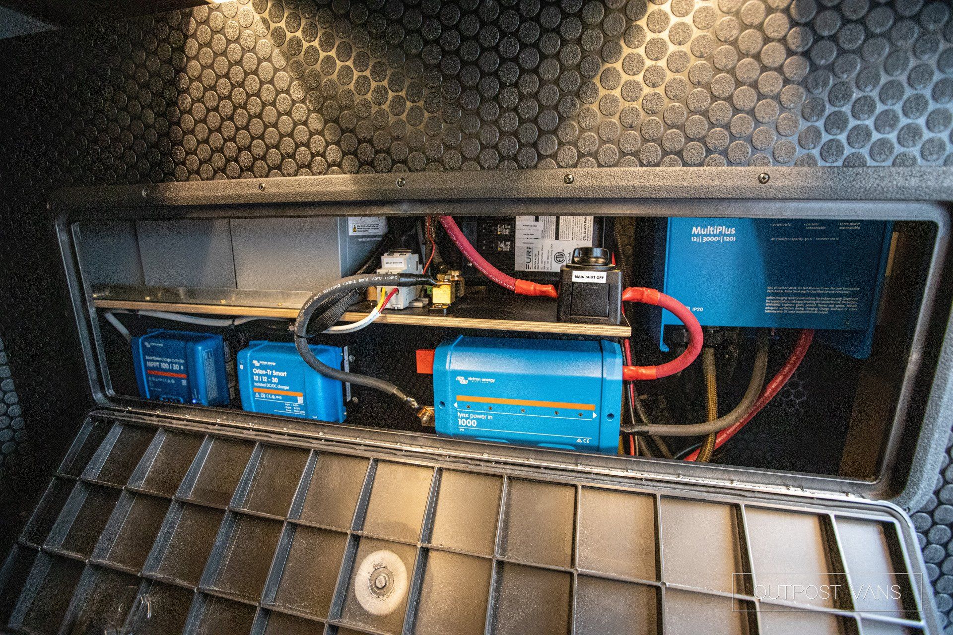 a bunch of wires are coming out of a box .