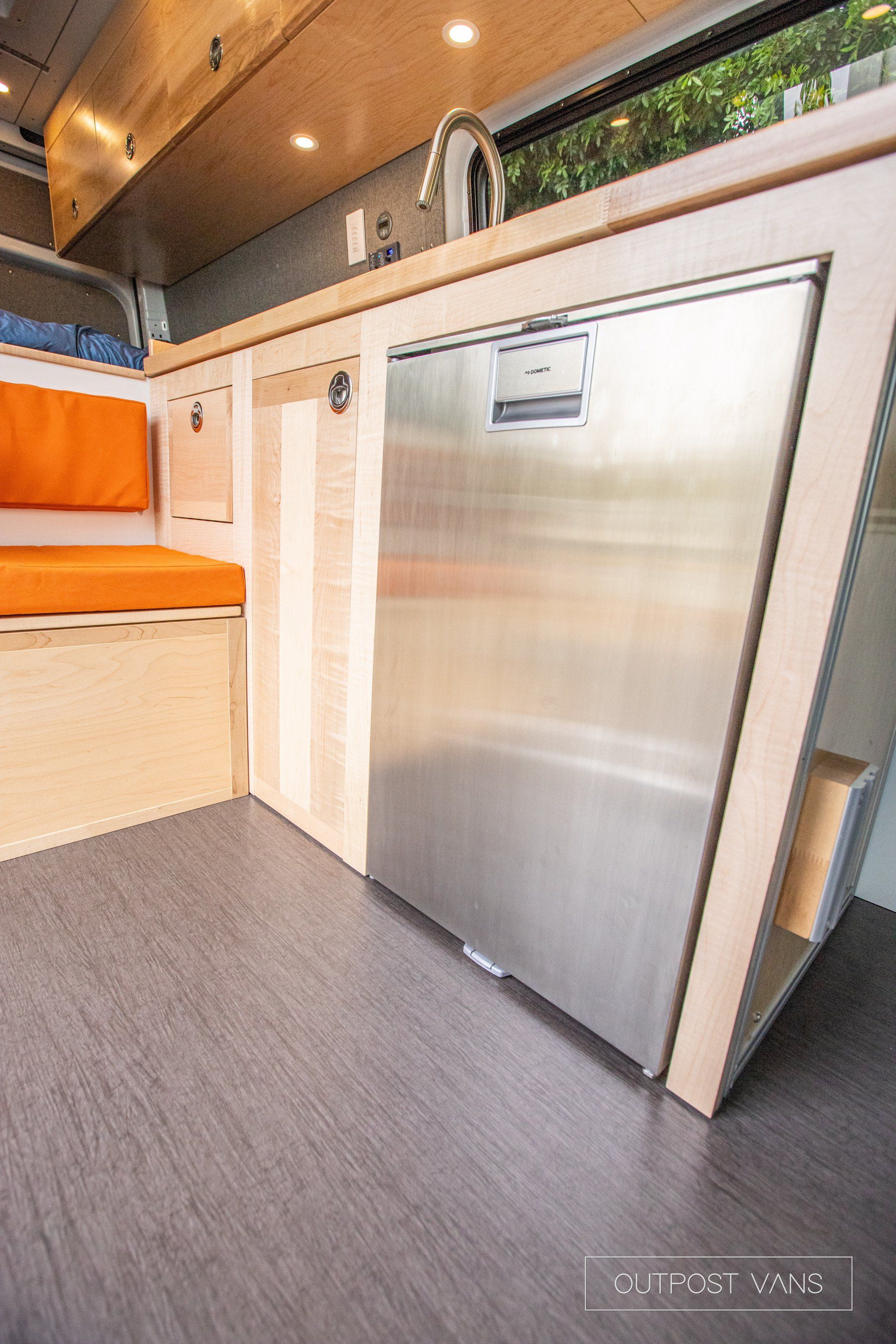 a stainless steel dishwasher is sitting under a counter in a kitchen .