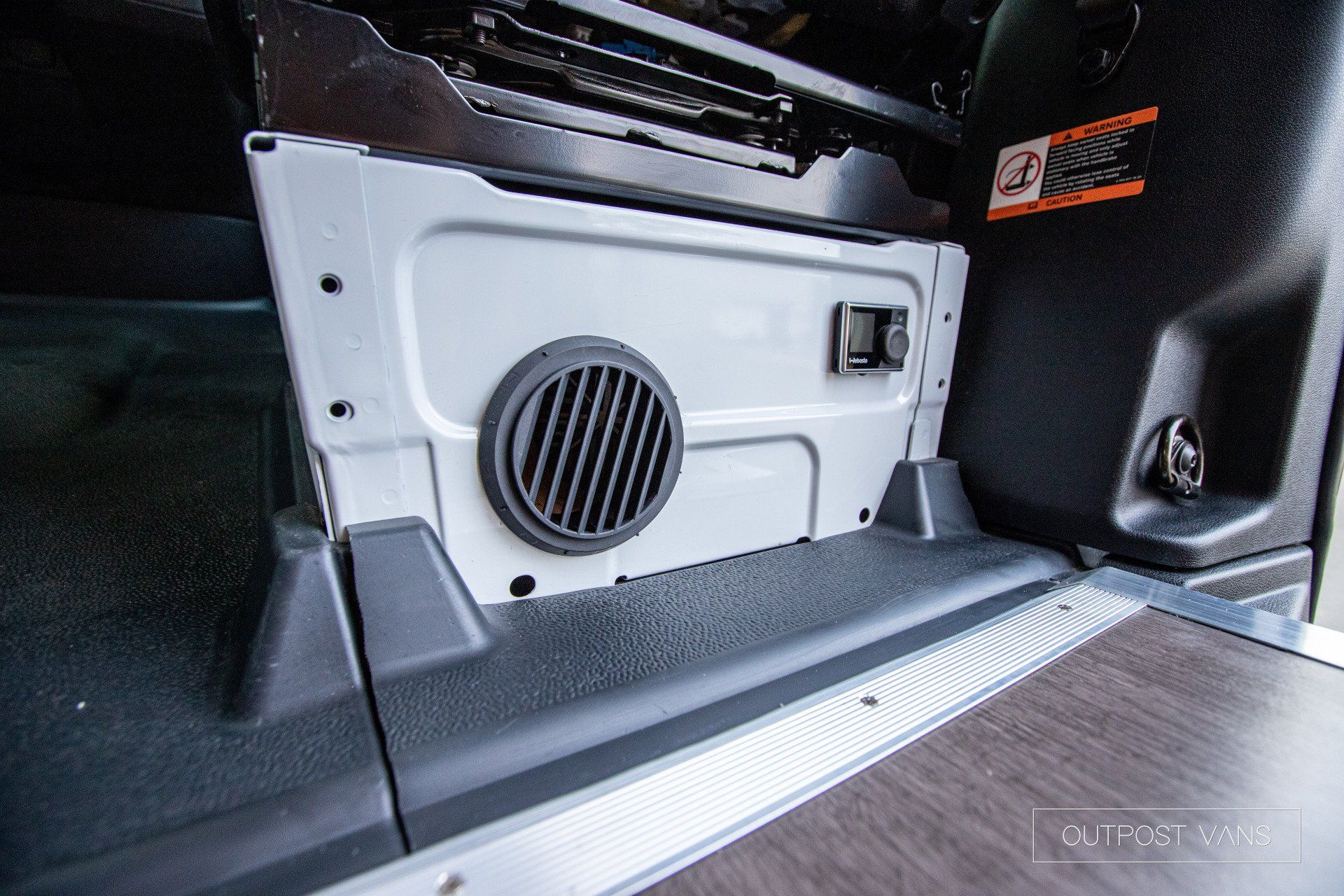 a close up of a speaker in the back of a car .