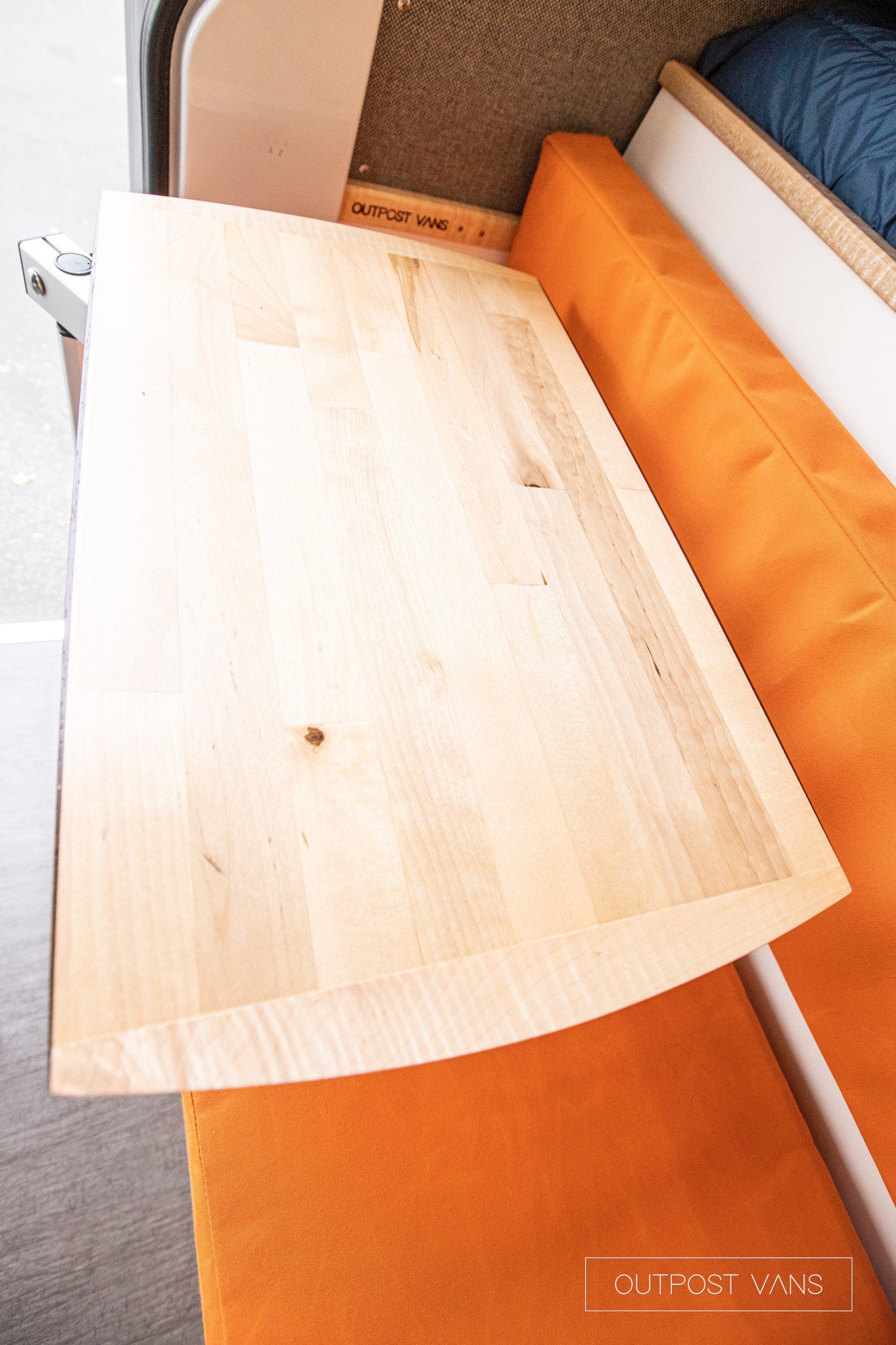 a wooden table is sitting on top of an orange couch