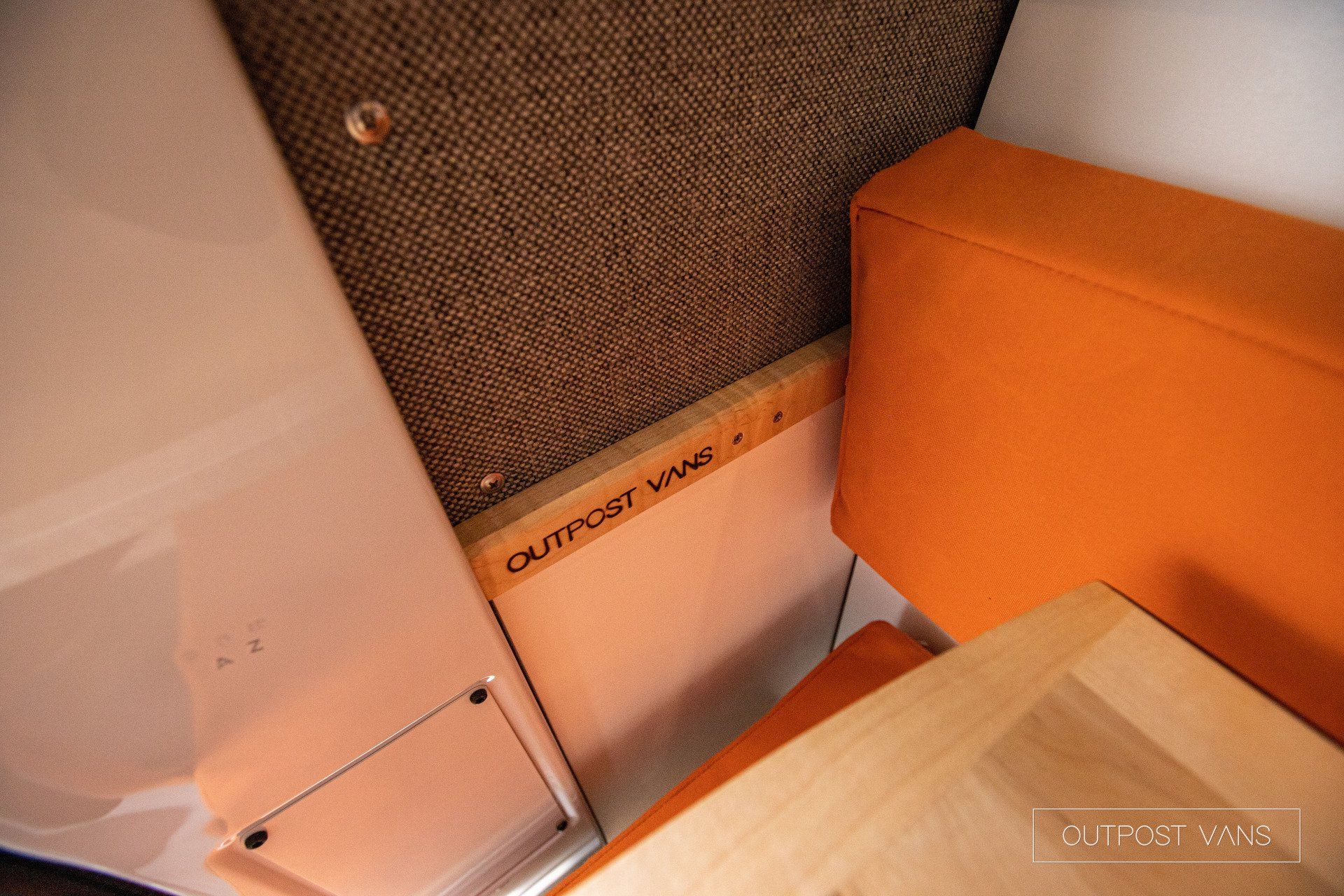 a room with a couch and a table and a sign that says outback van