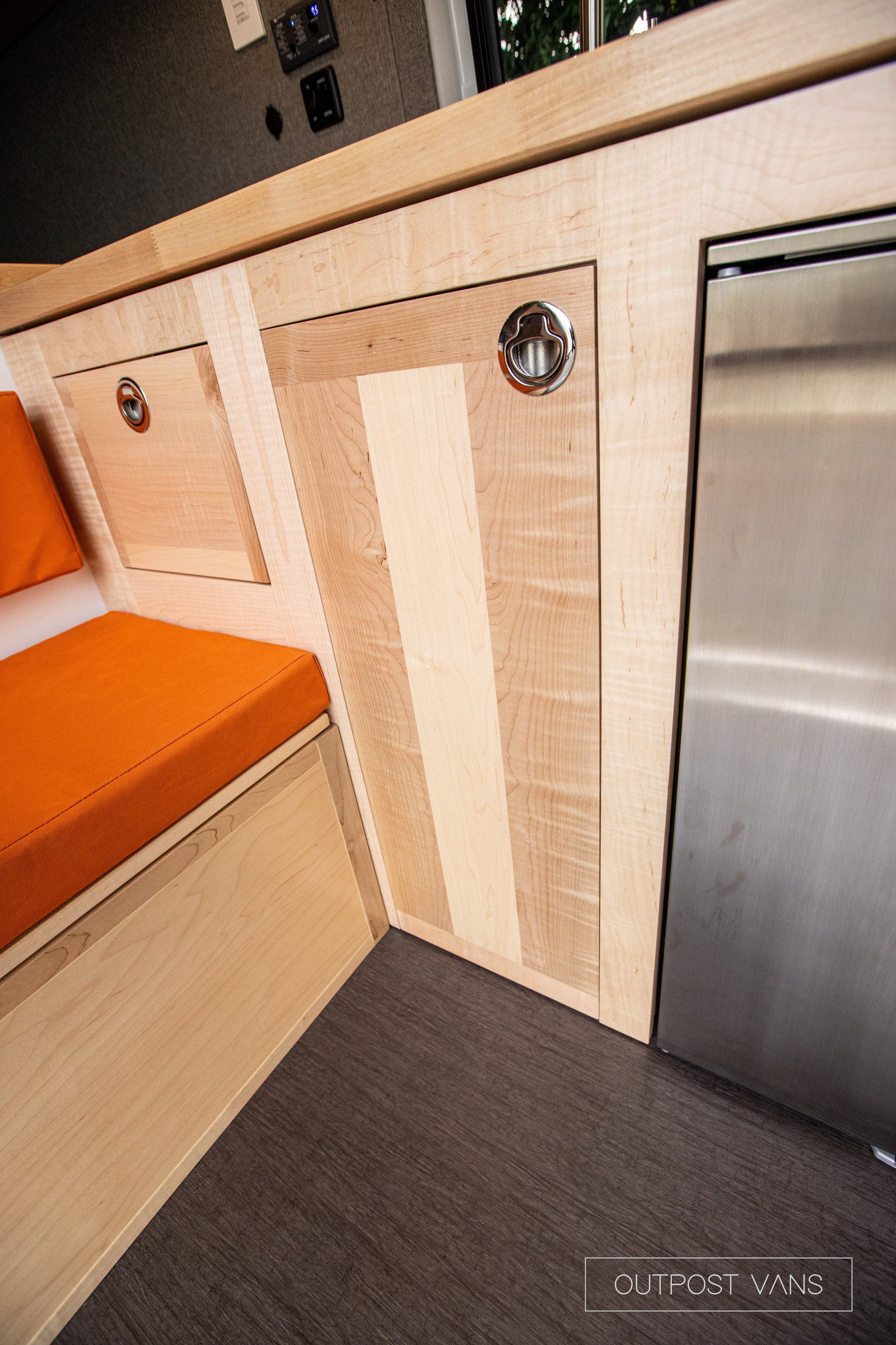 a kitchen with wooden cabinets and a stainless steel dishwasher