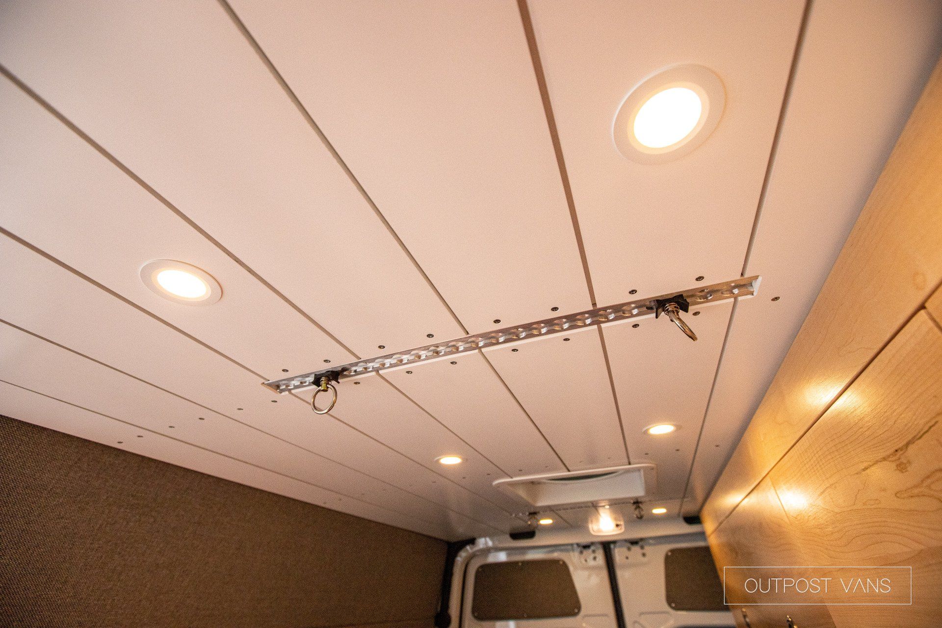 the ceiling of a van with a ladder attached to it .
