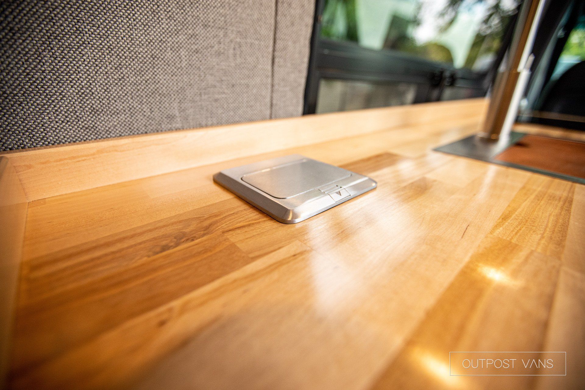 a small device is sitting on top of a wooden table .