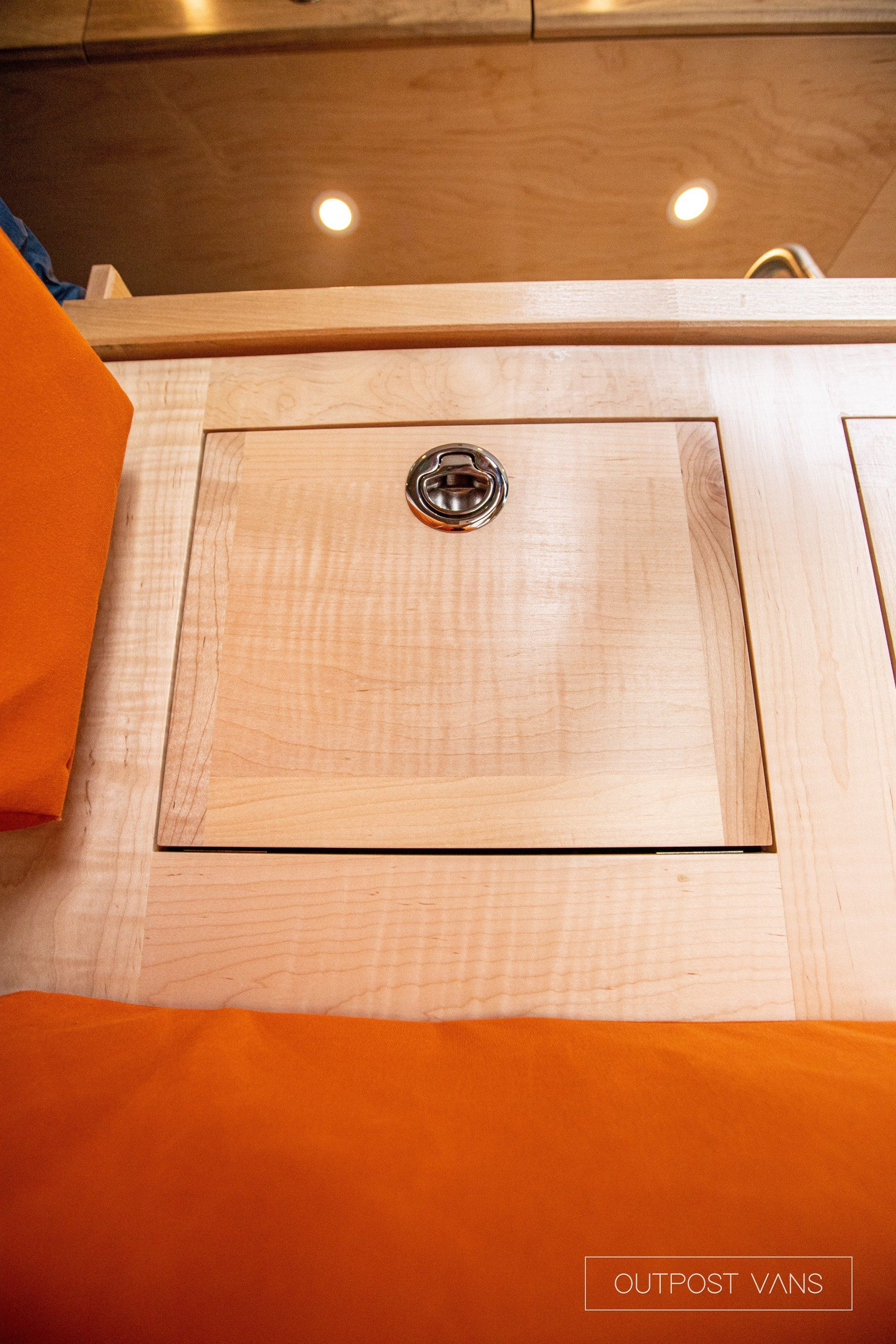 a wooden table with a screw in the middle of it .