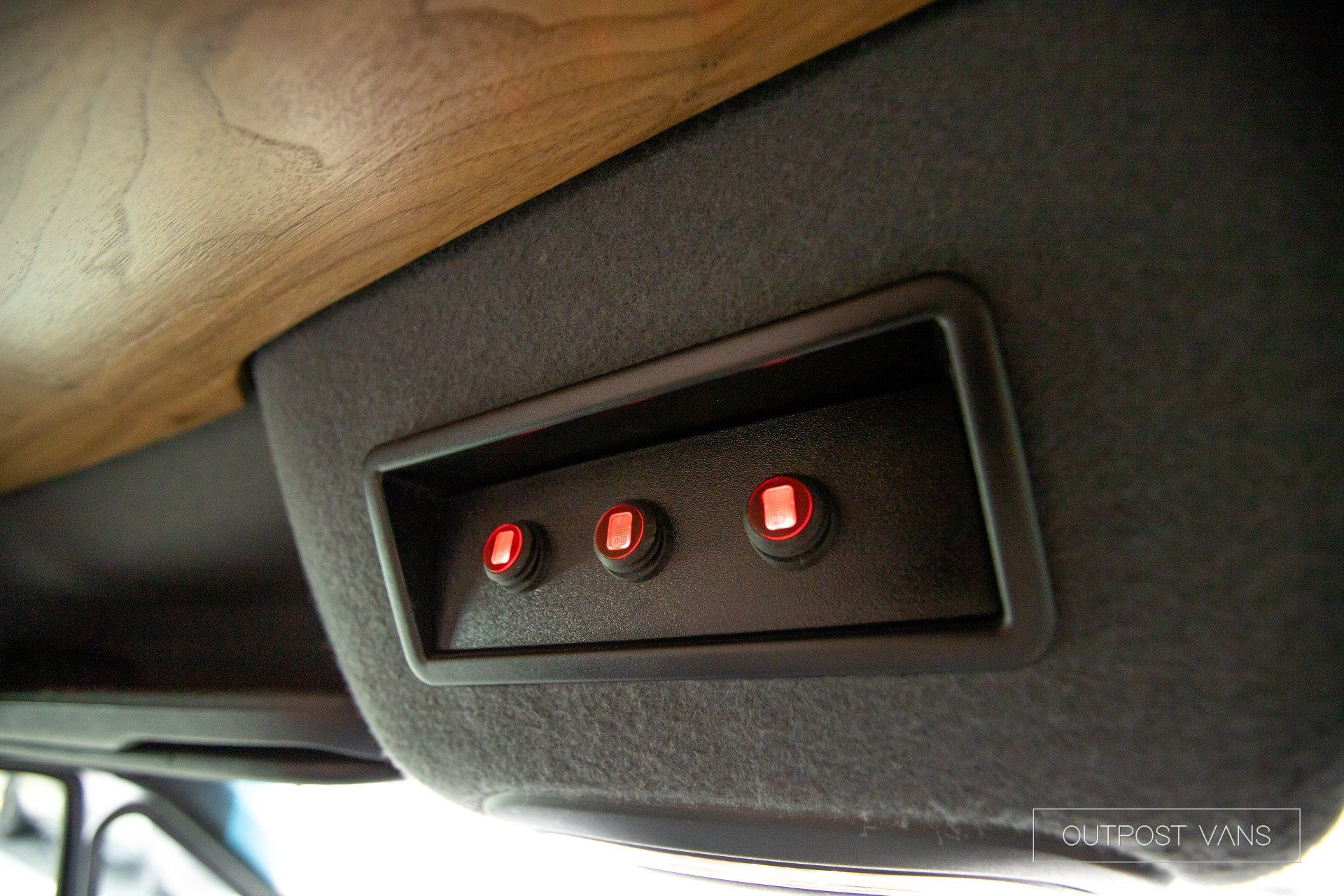 There are three red lights on the side of a car.