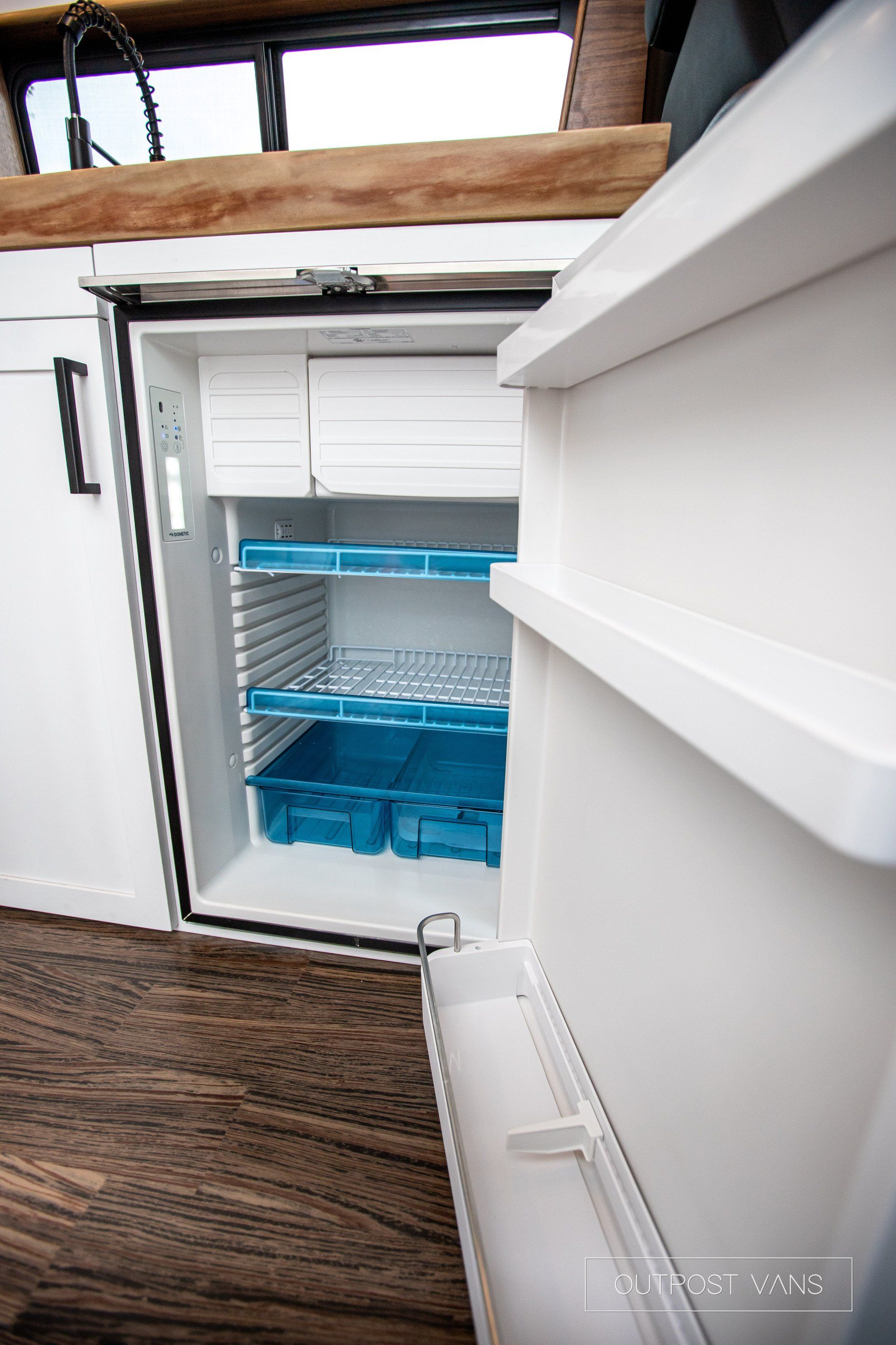 The inside of an empty refrigerator with the door open.