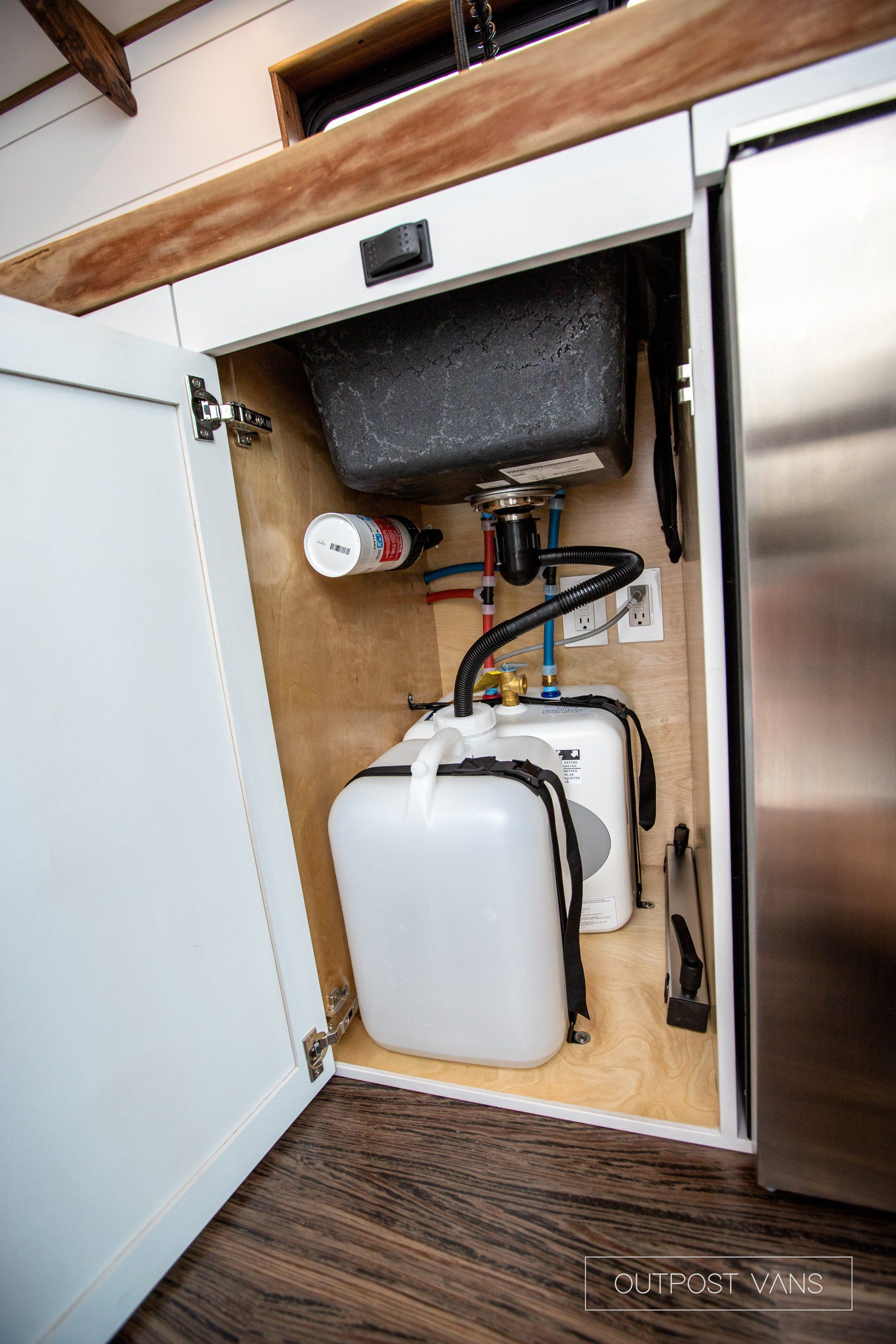 A sink is sitting under a cabinet in a kitchen.