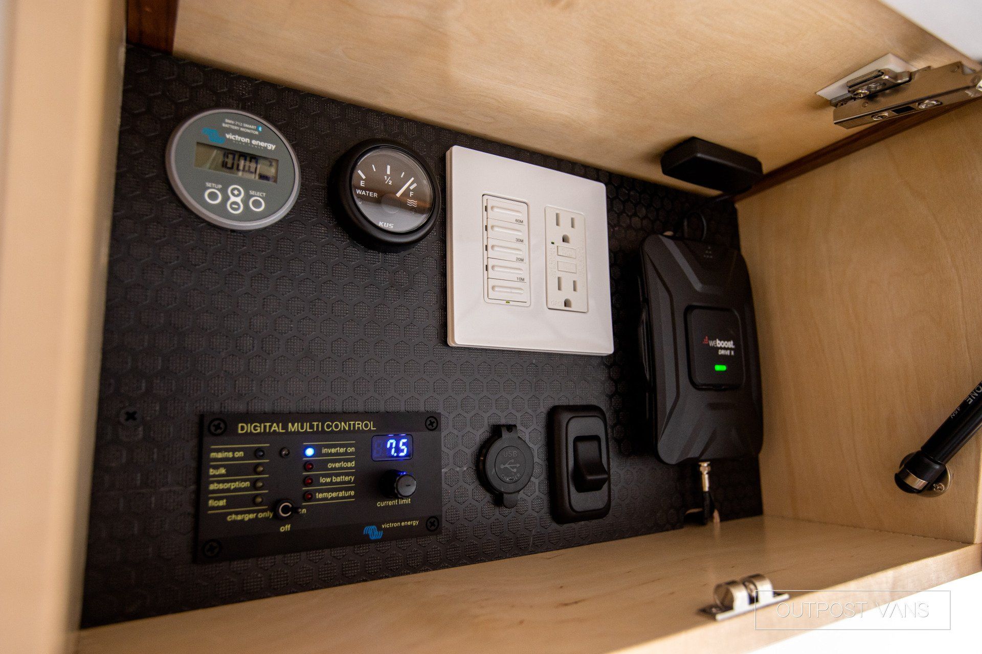 A wooden cabinet with a bunch of electronic devices on it