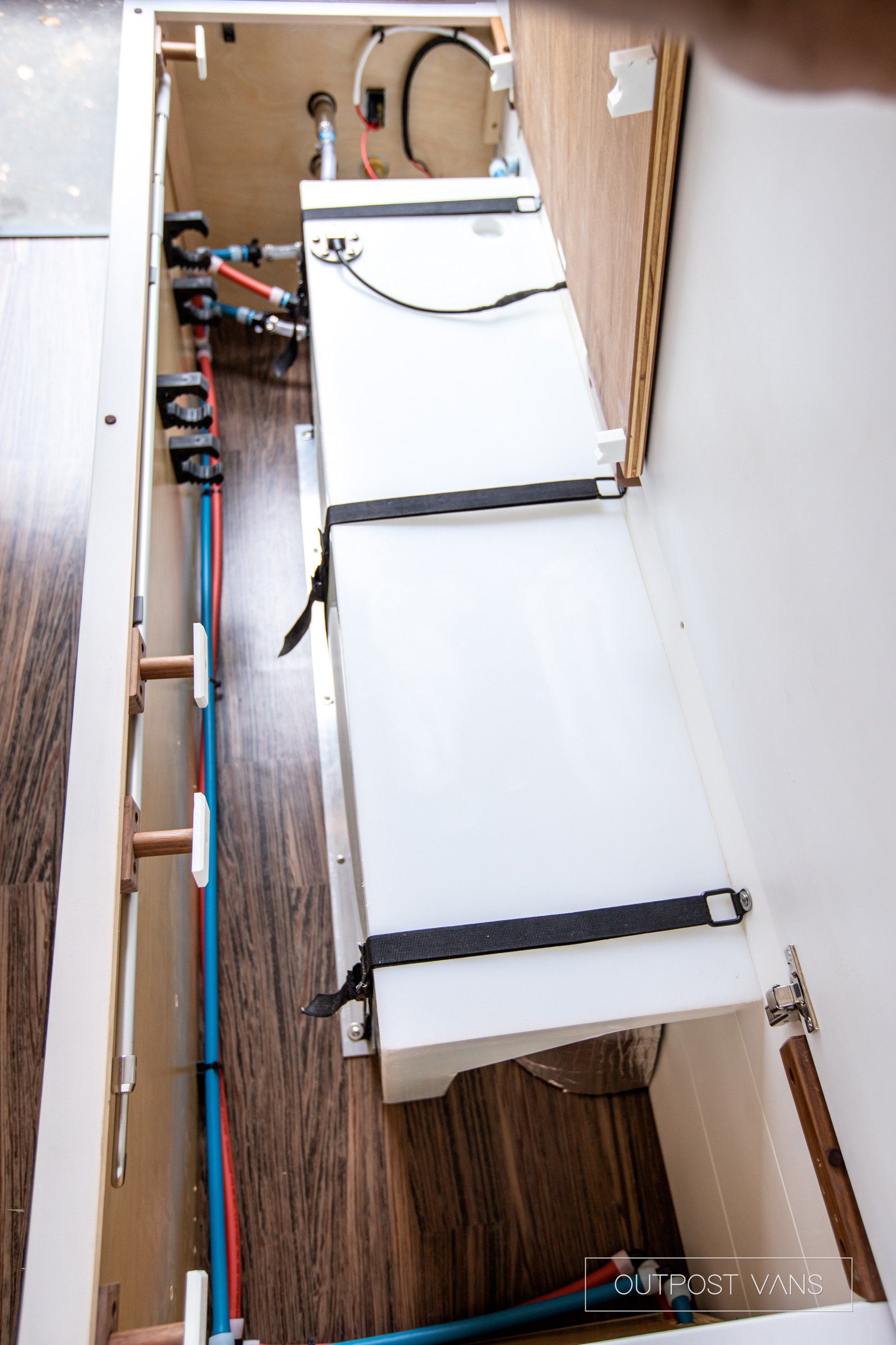 An aerial view of a kitchen with a sink and pipes.