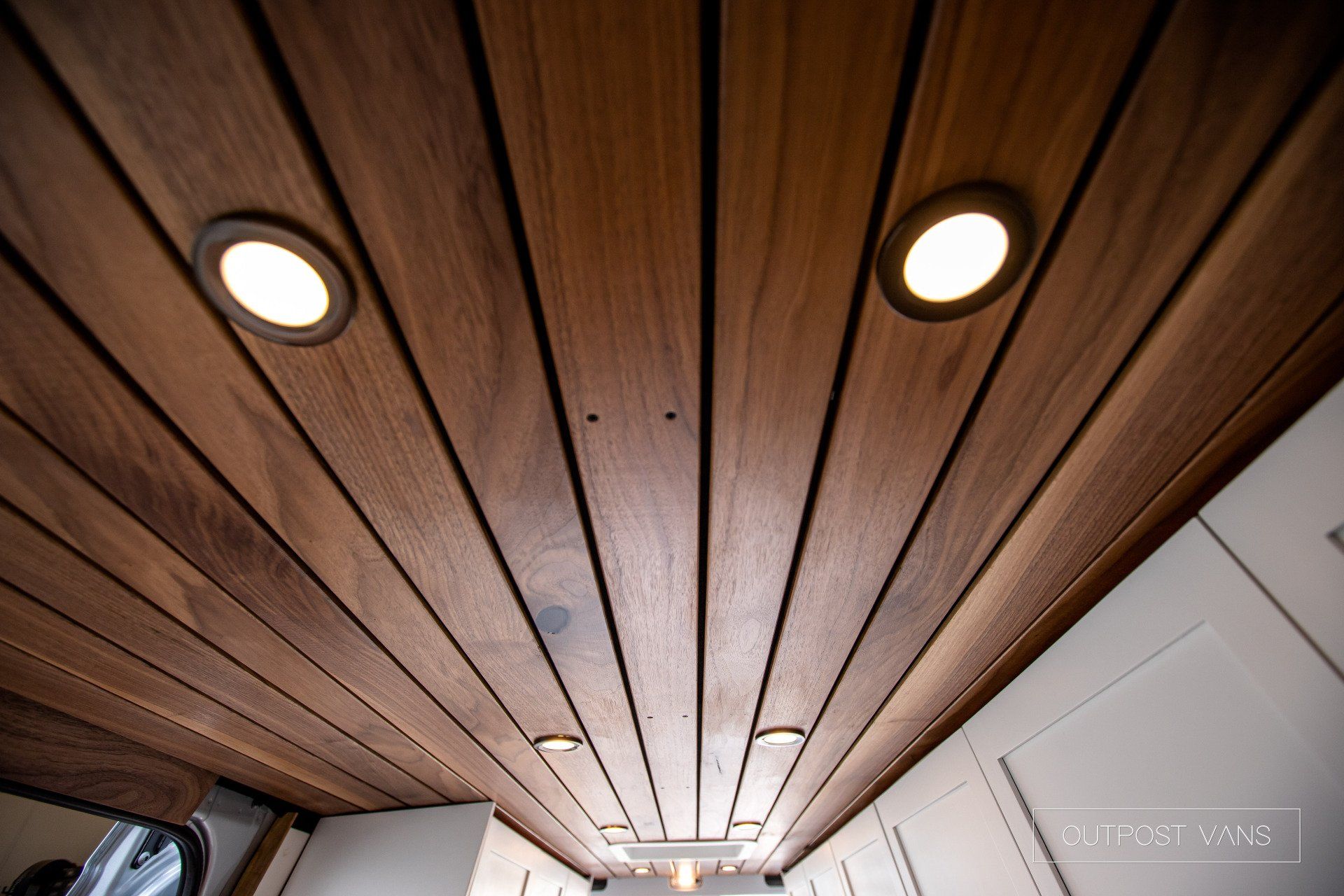 A wooden ceiling with a few lights on it