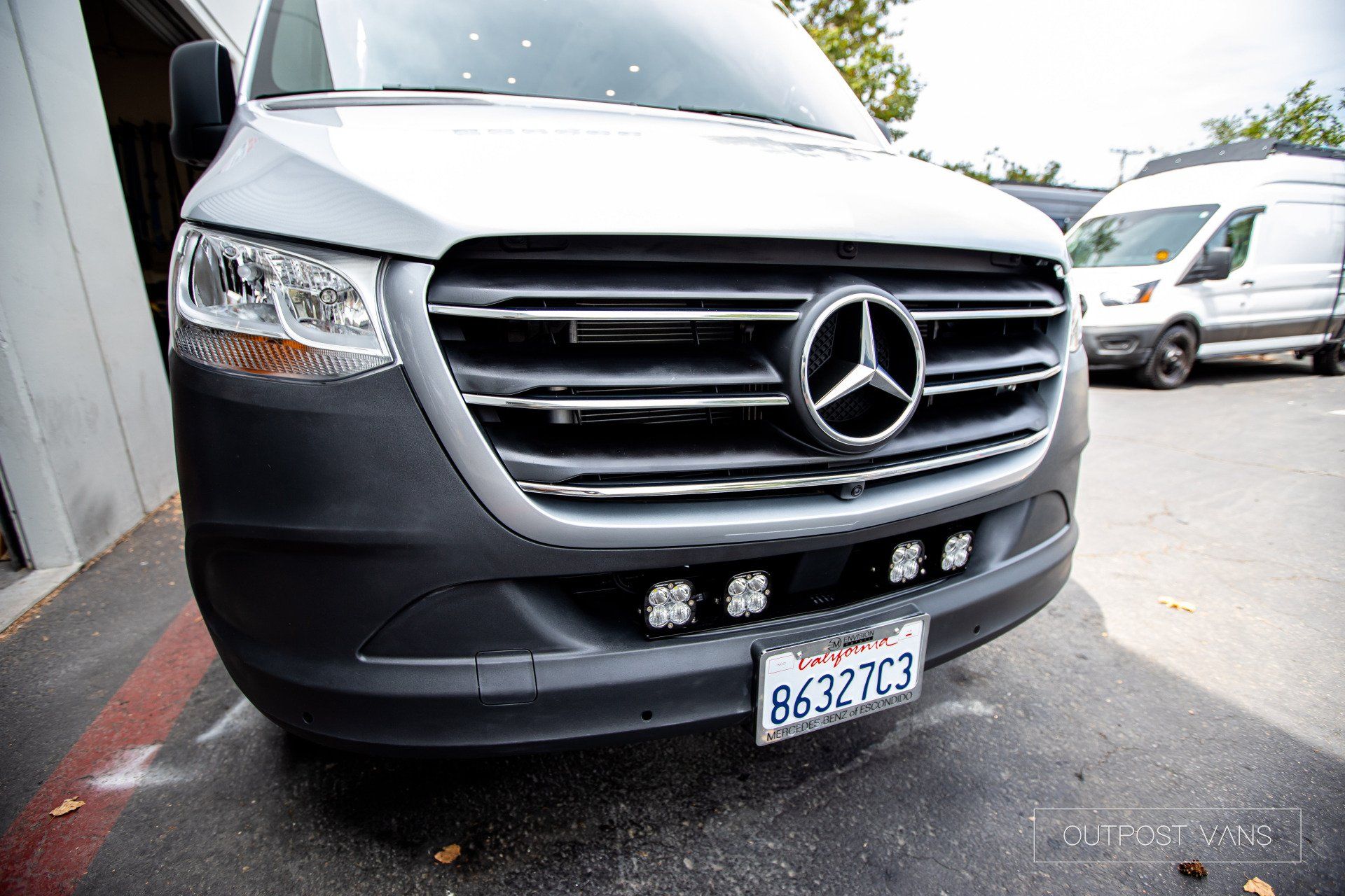 A mercedes sprinter van is parked in a parking lot