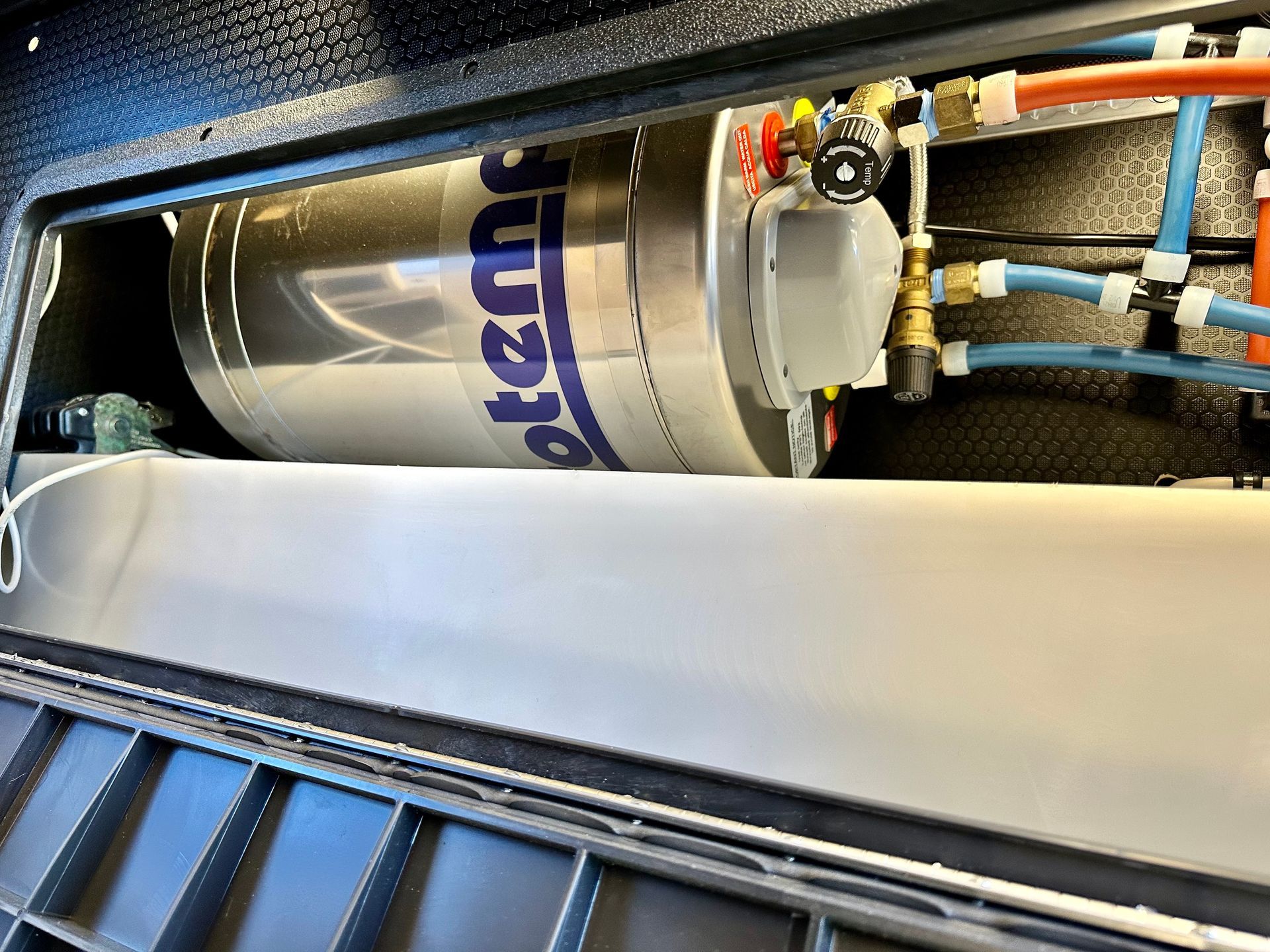 A water filter is sitting inside of a metal box.