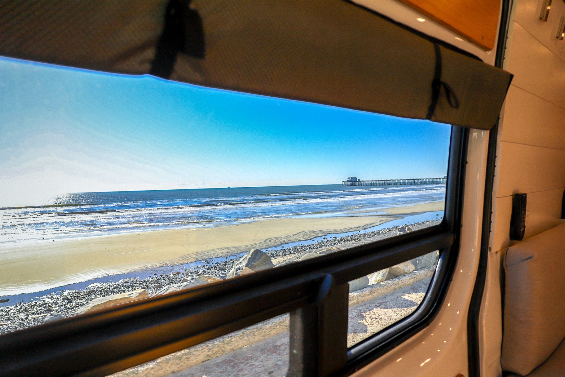a view of the ocean from a window in a van