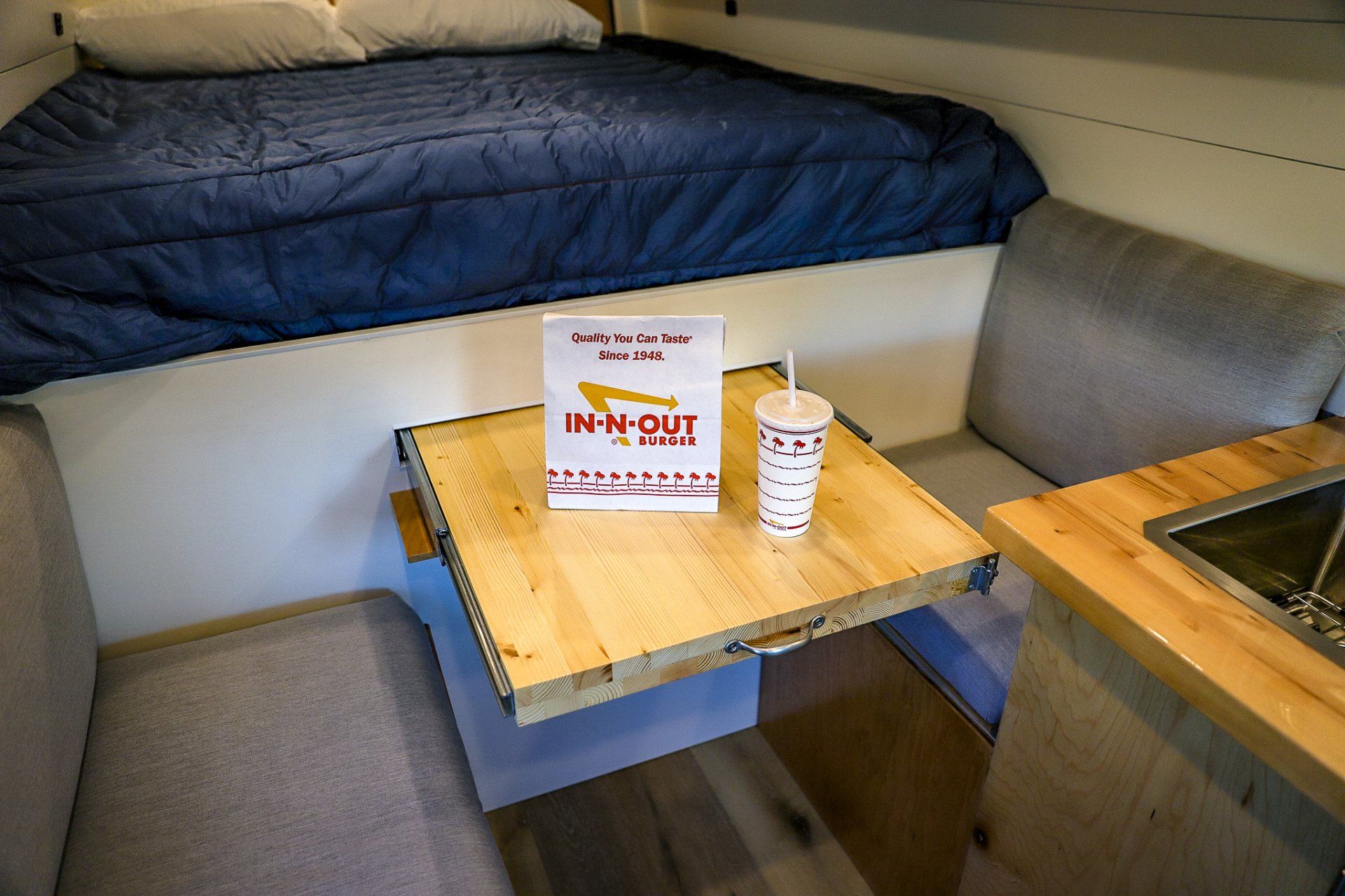 a table with a cup and a sign that says in-n-out on it .