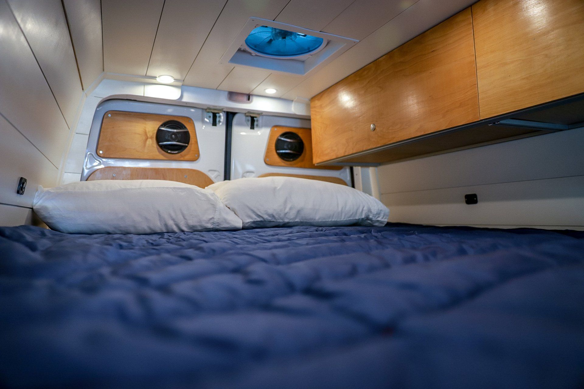 there is a bed in the back of a van .