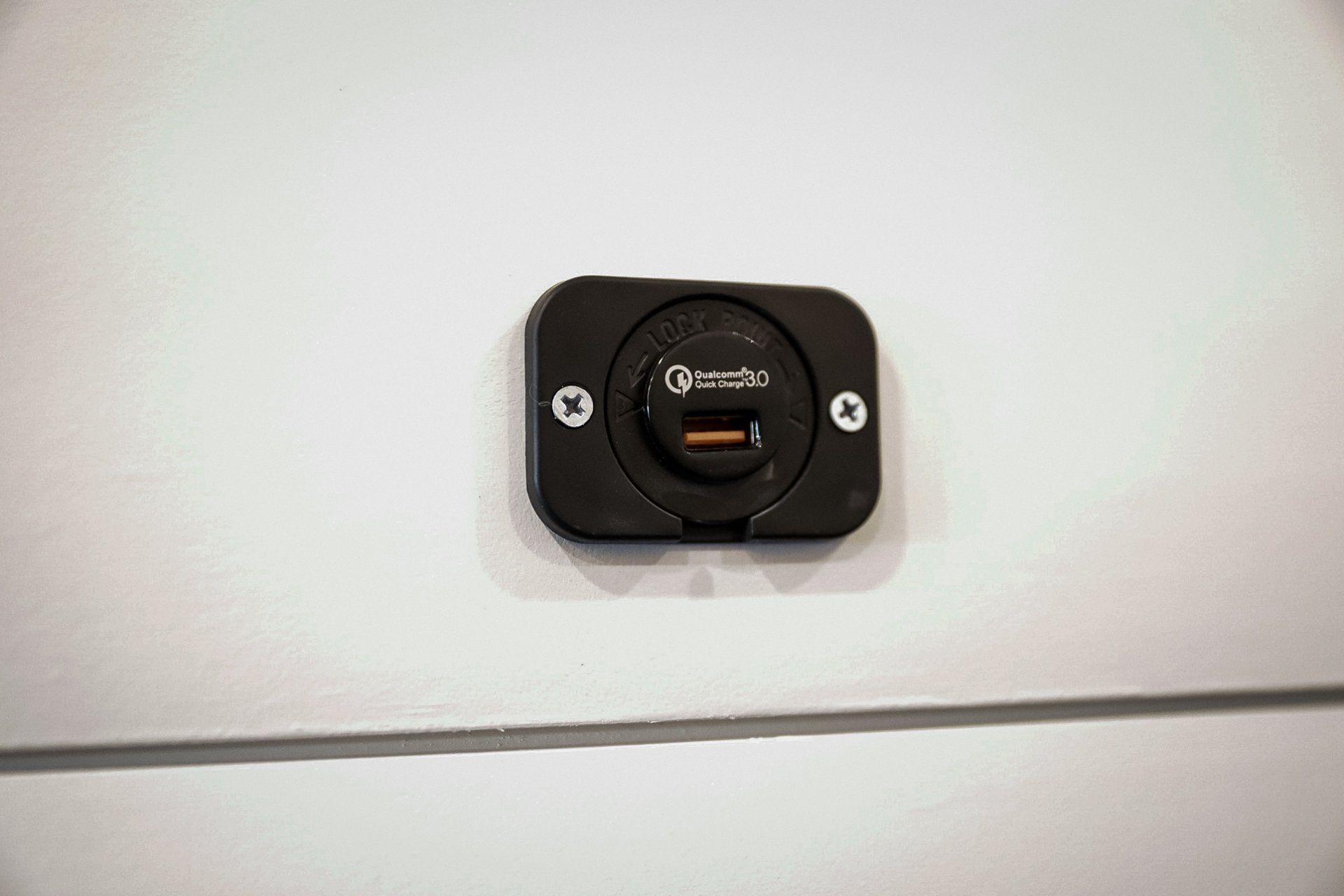 a close up of a charger plugged into a wall .