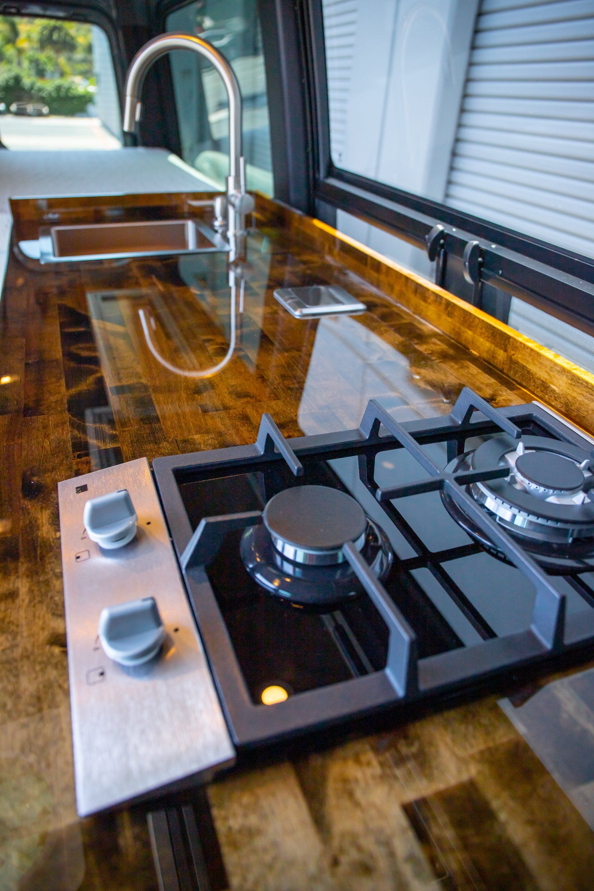 a stove top oven is sitting on top of a wooden counter in a kitchen .