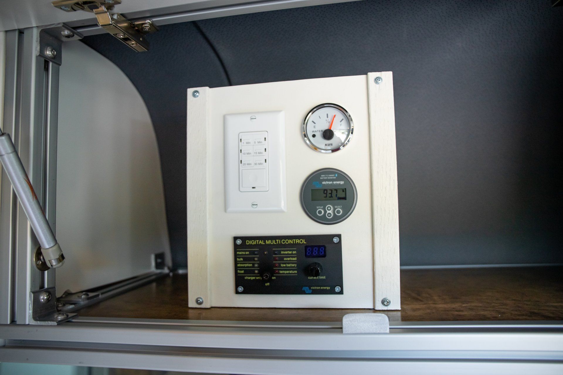 a white box with a clock and a light switch on it