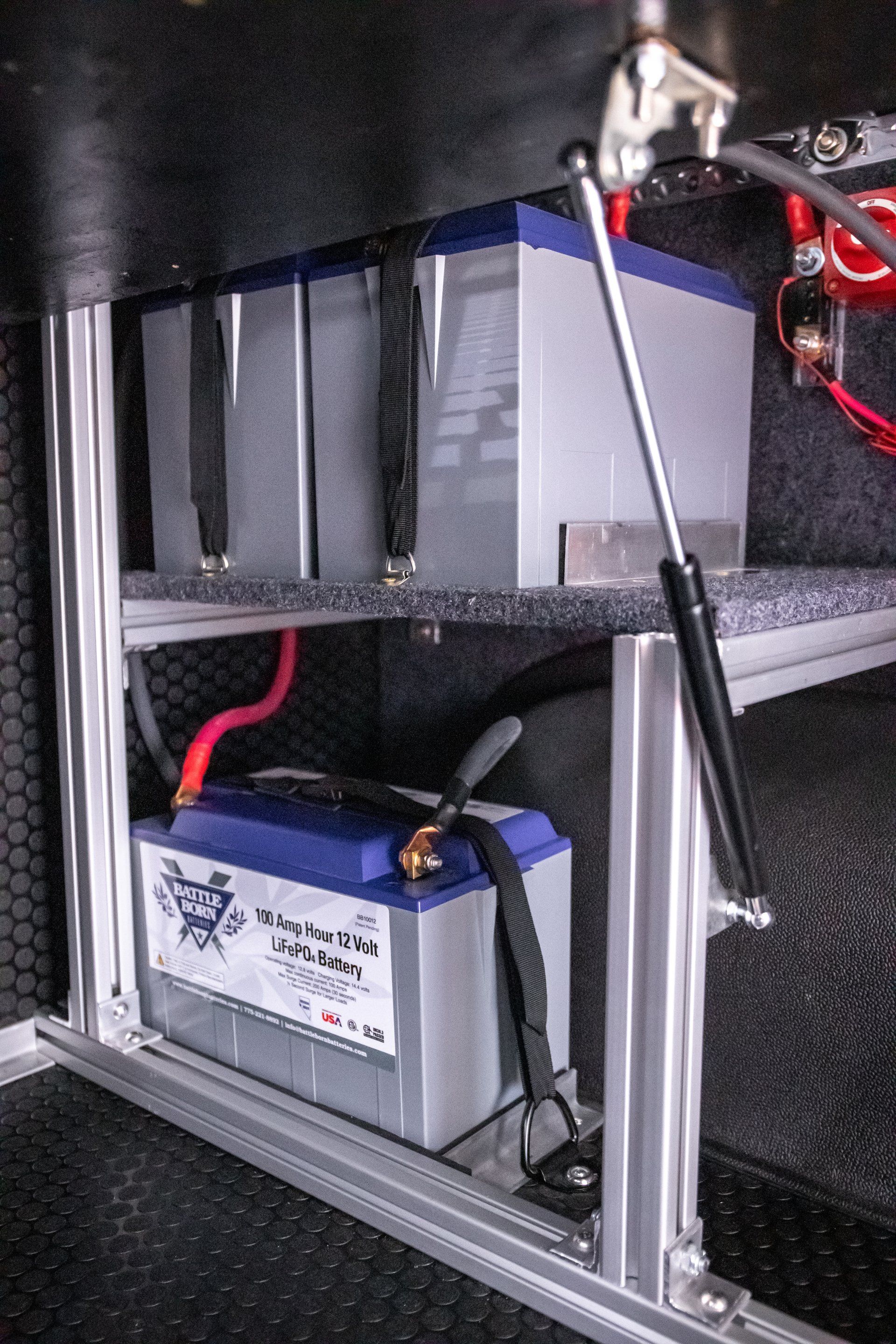 a blue battery is sitting on top of a metal shelf .