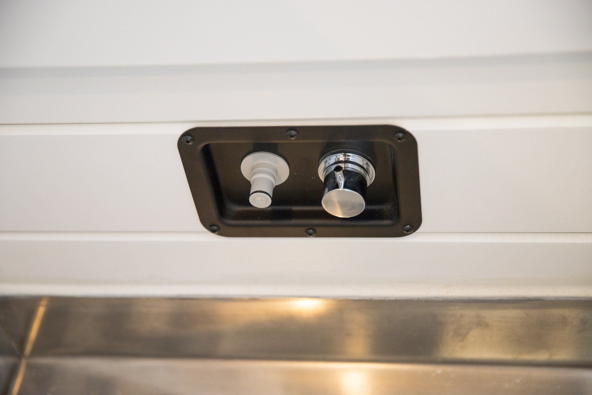 a close up of a faucet on the ceiling of a refrigerator .