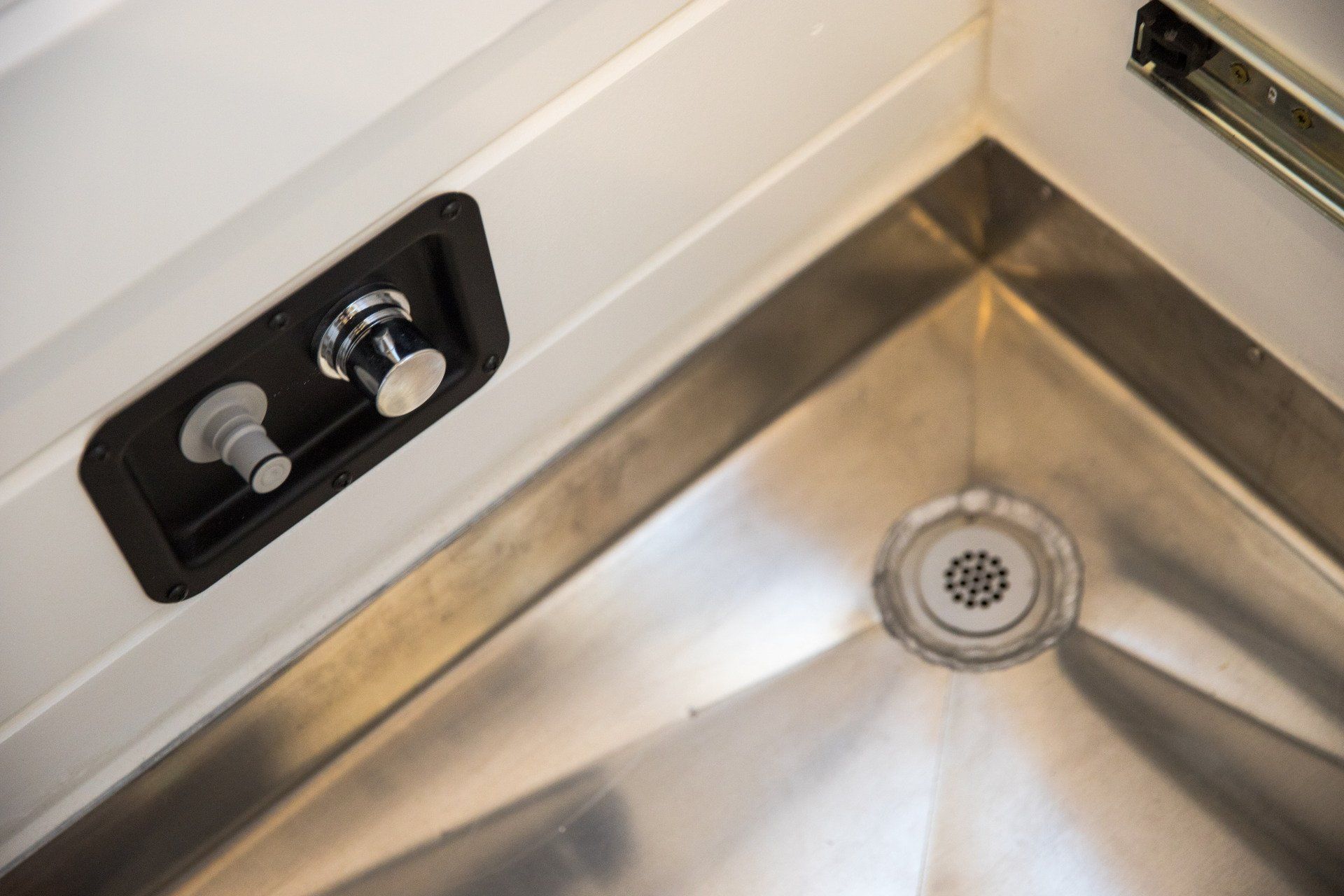 a close up of a stainless steel sink with a drain .