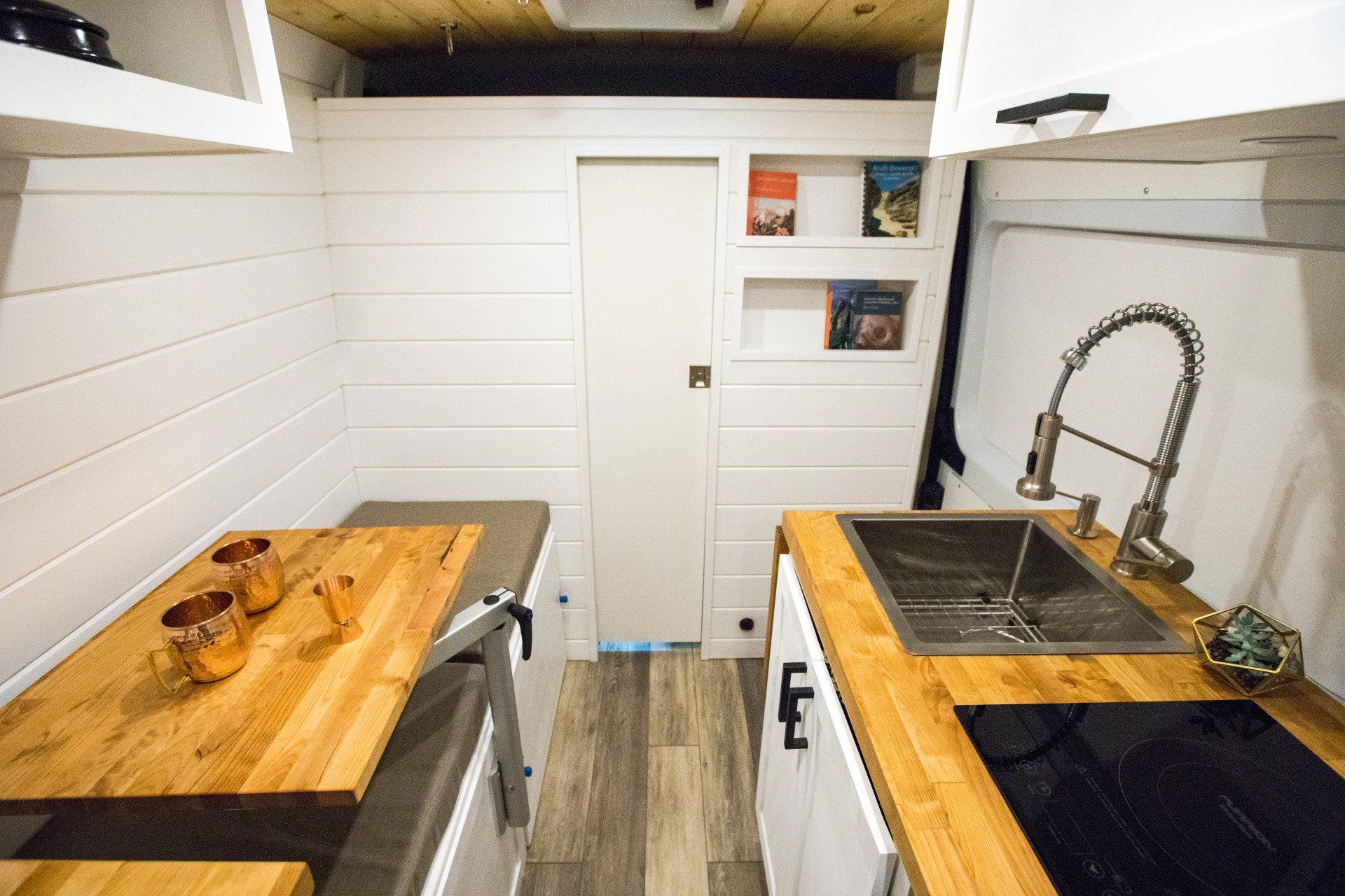 a kitchen with a sink , stove , and table .