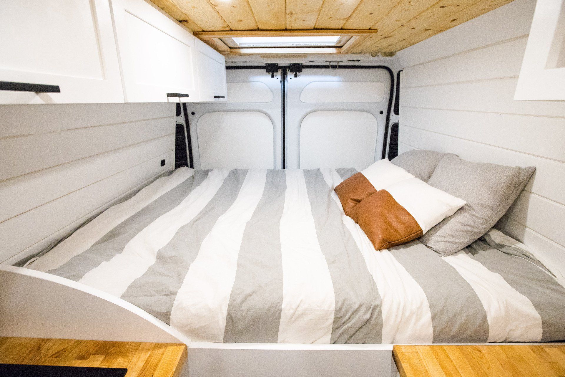 there is a bed in the back of a van .