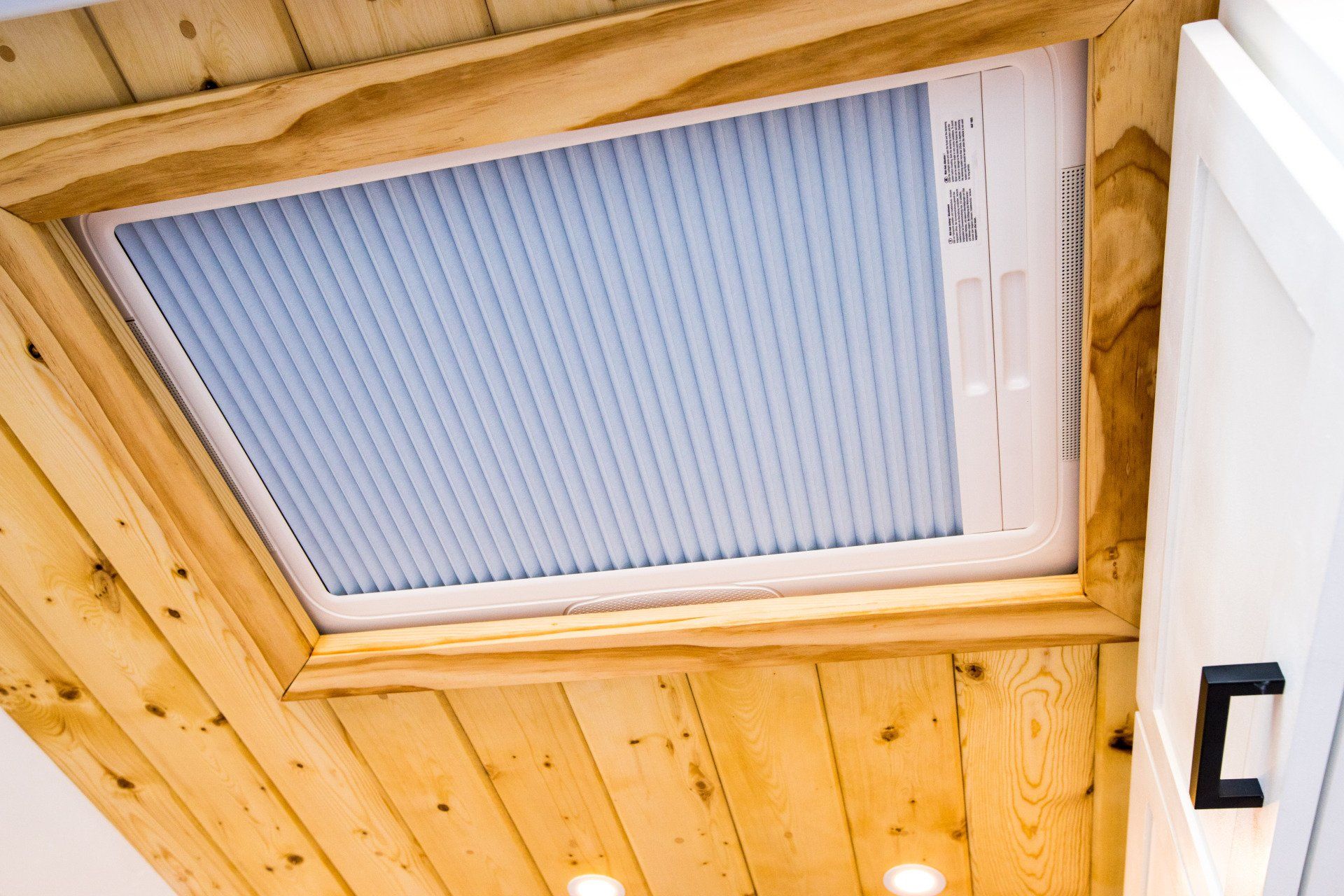there is a skylight in the ceiling of a room .