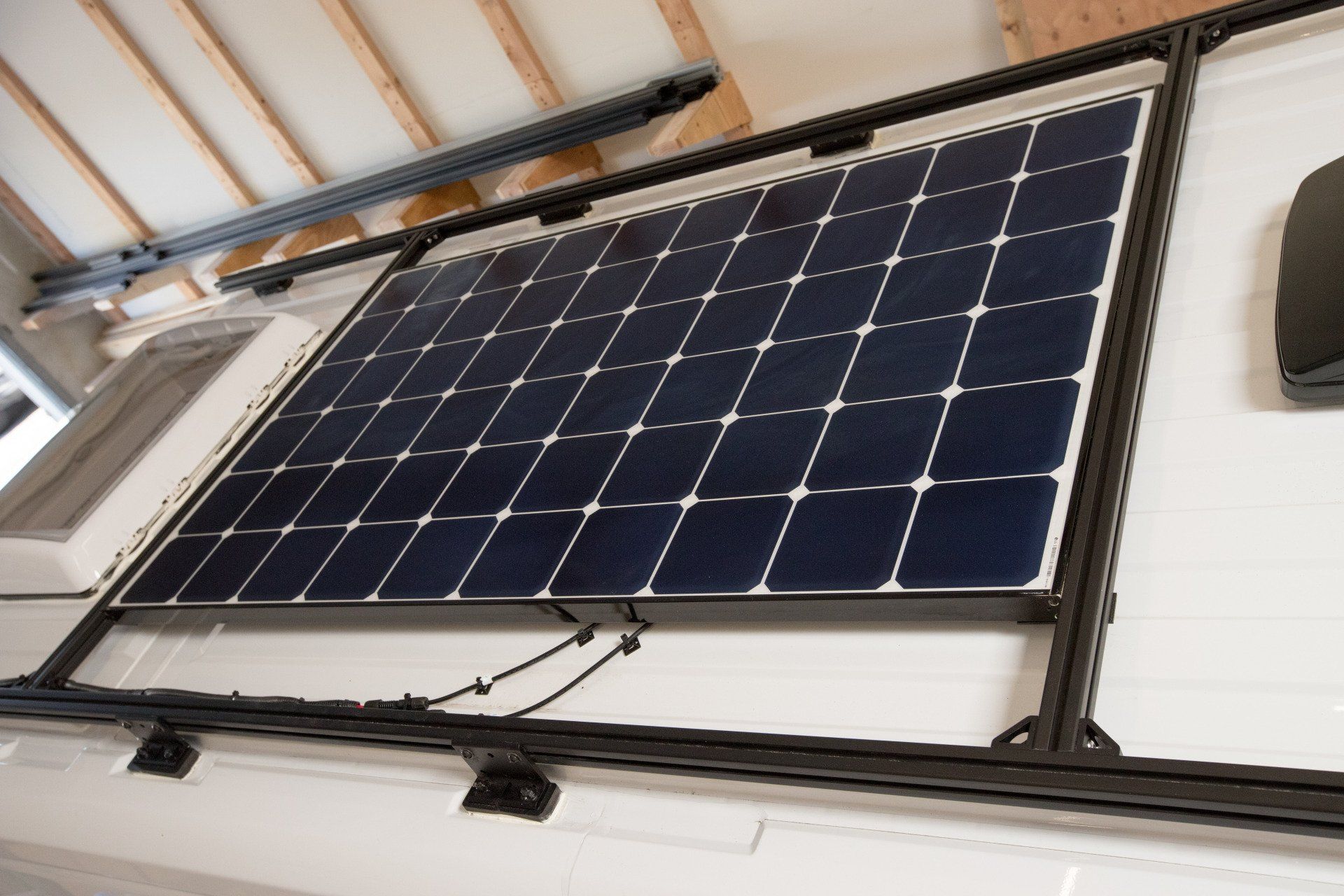 a solar panel is mounted to the roof of a building