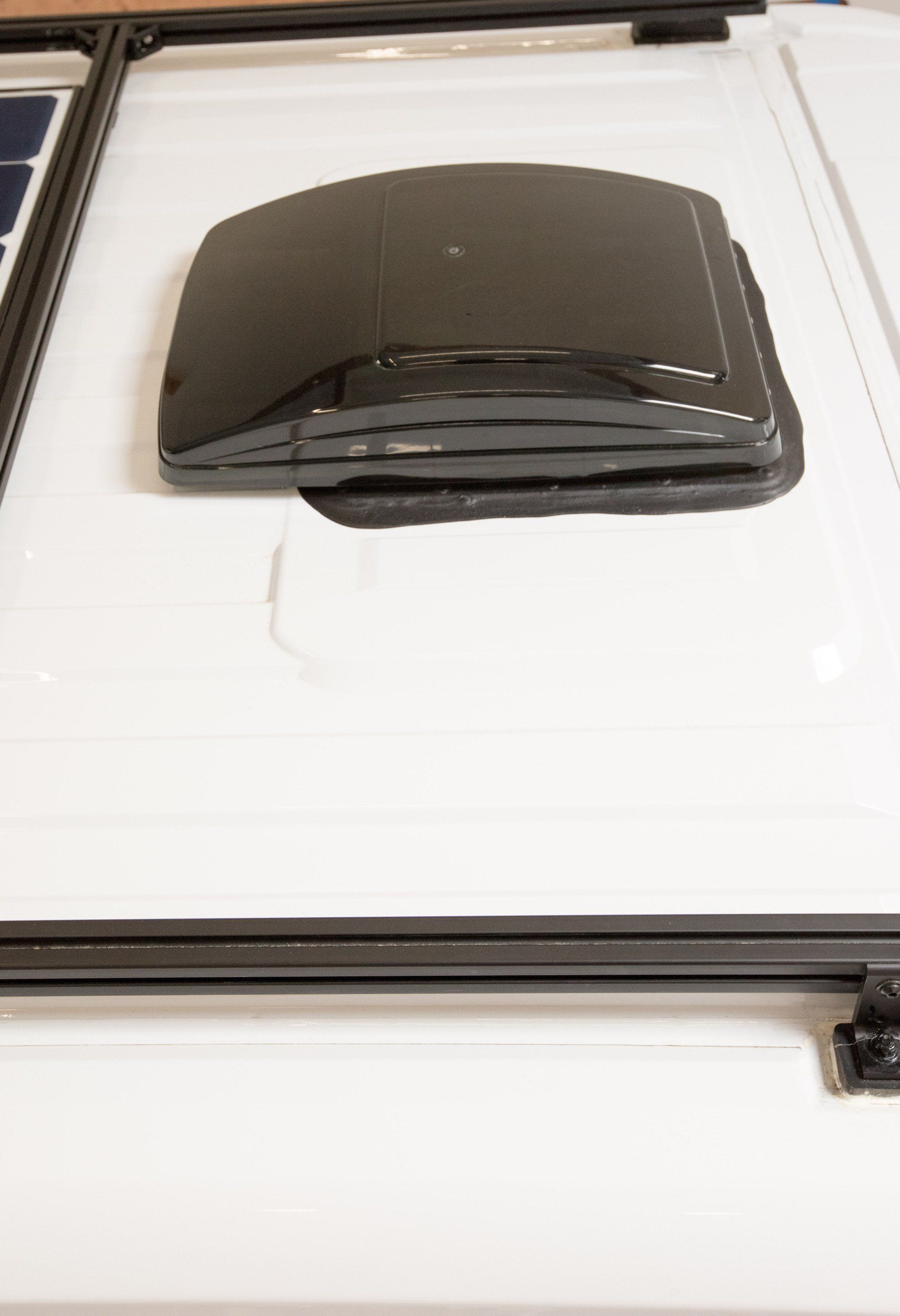 a black object is sitting on top of a white surface .