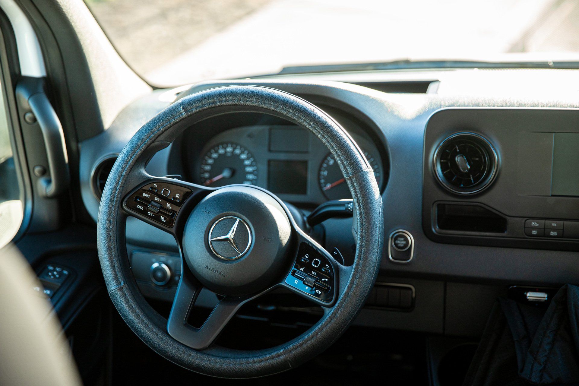 a close up of the steering wheel and dashboard of a mercedes van .
