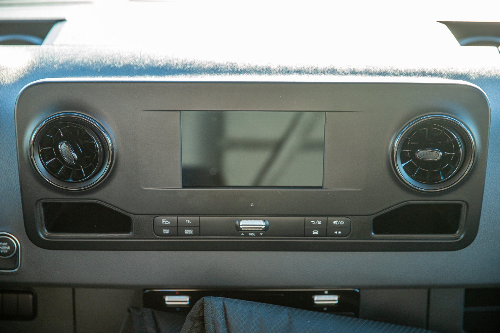 a close up of a car dashboard with a radio and air vents .