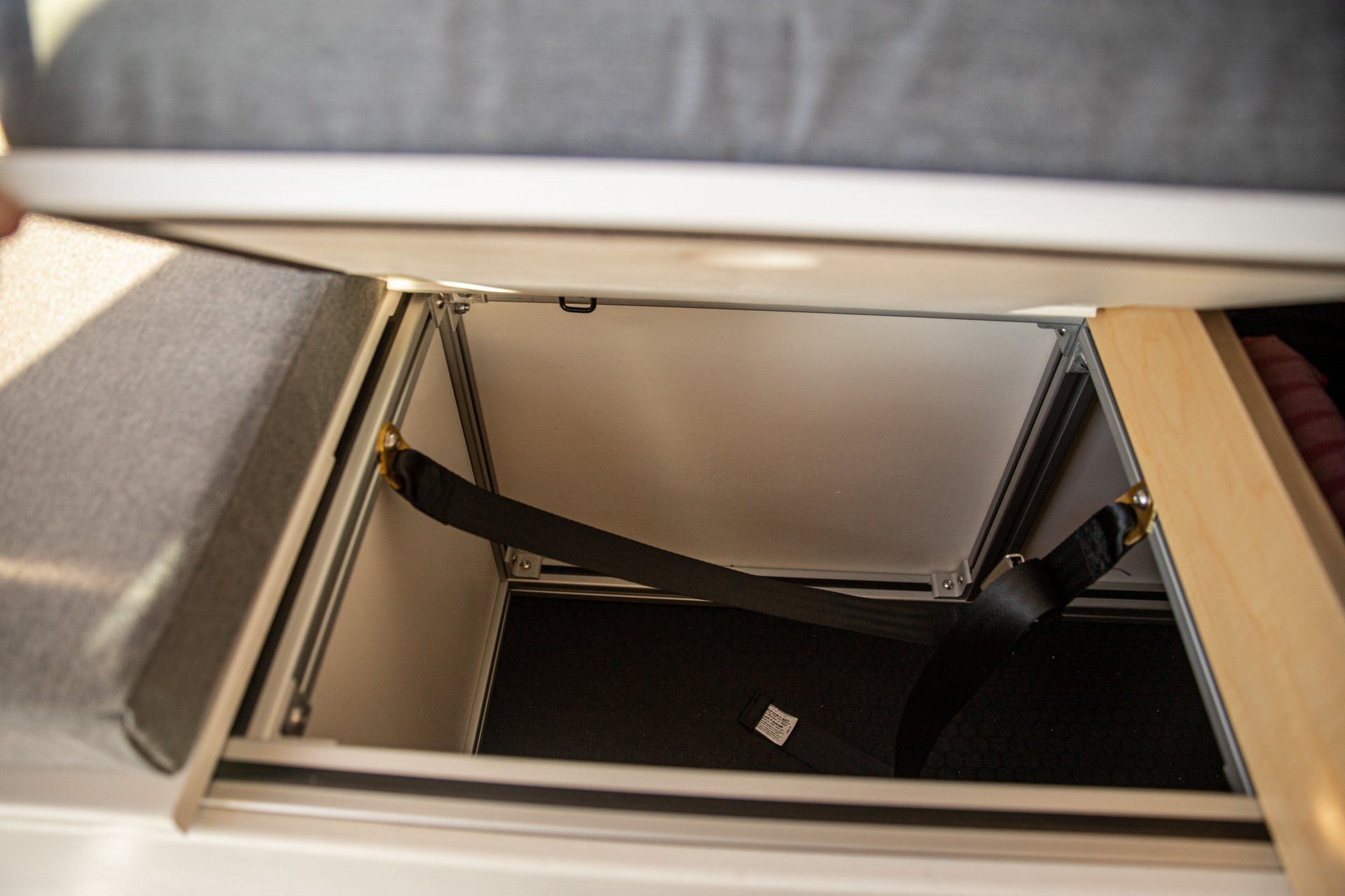 a person is opening a trunk in a camper .