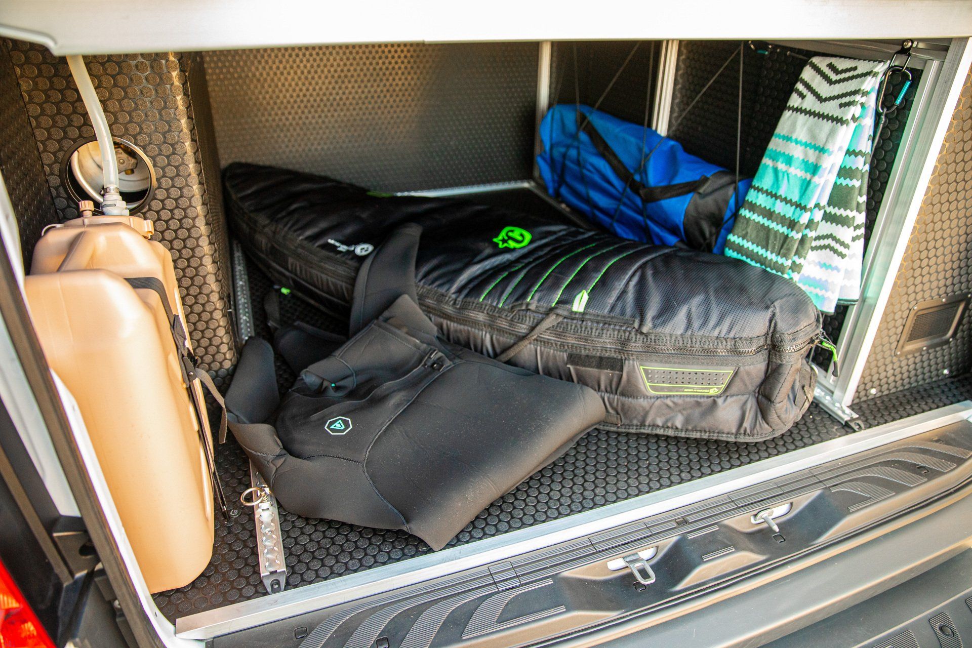 the trunk of a van is filled with a lot of luggage .