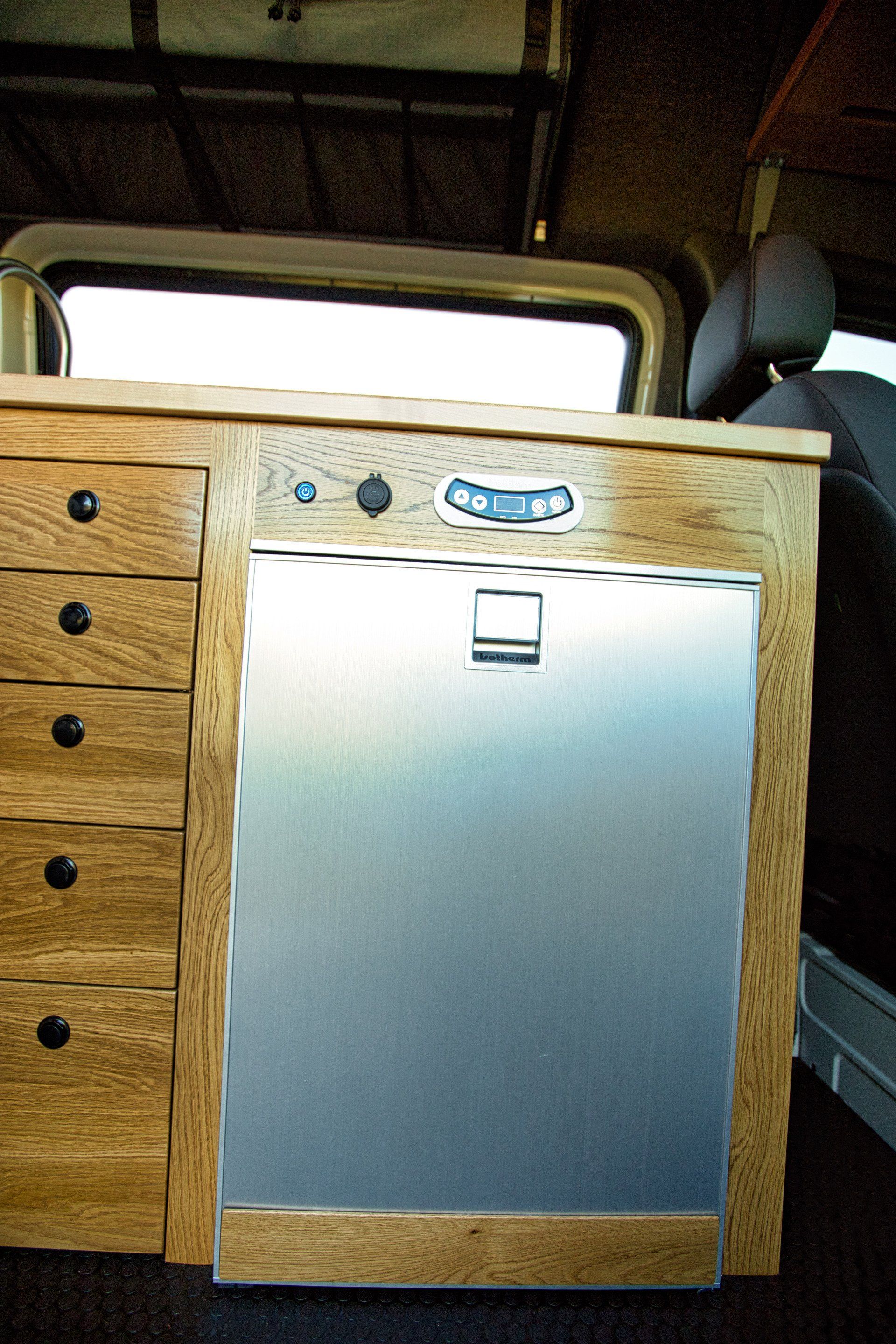 A wooden cabinet with a stainless steel door