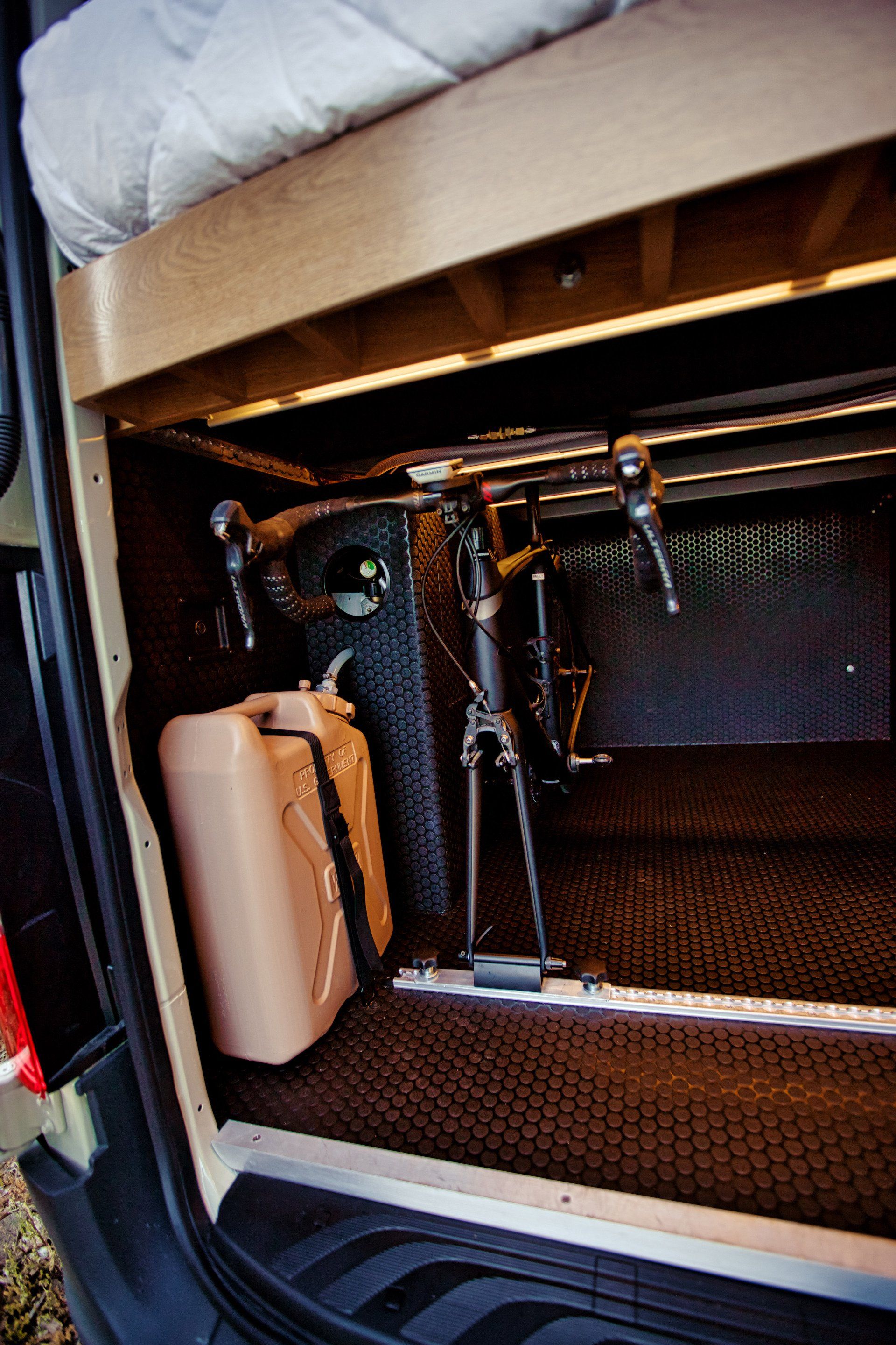 A bicycle is sitting in the back of a van.