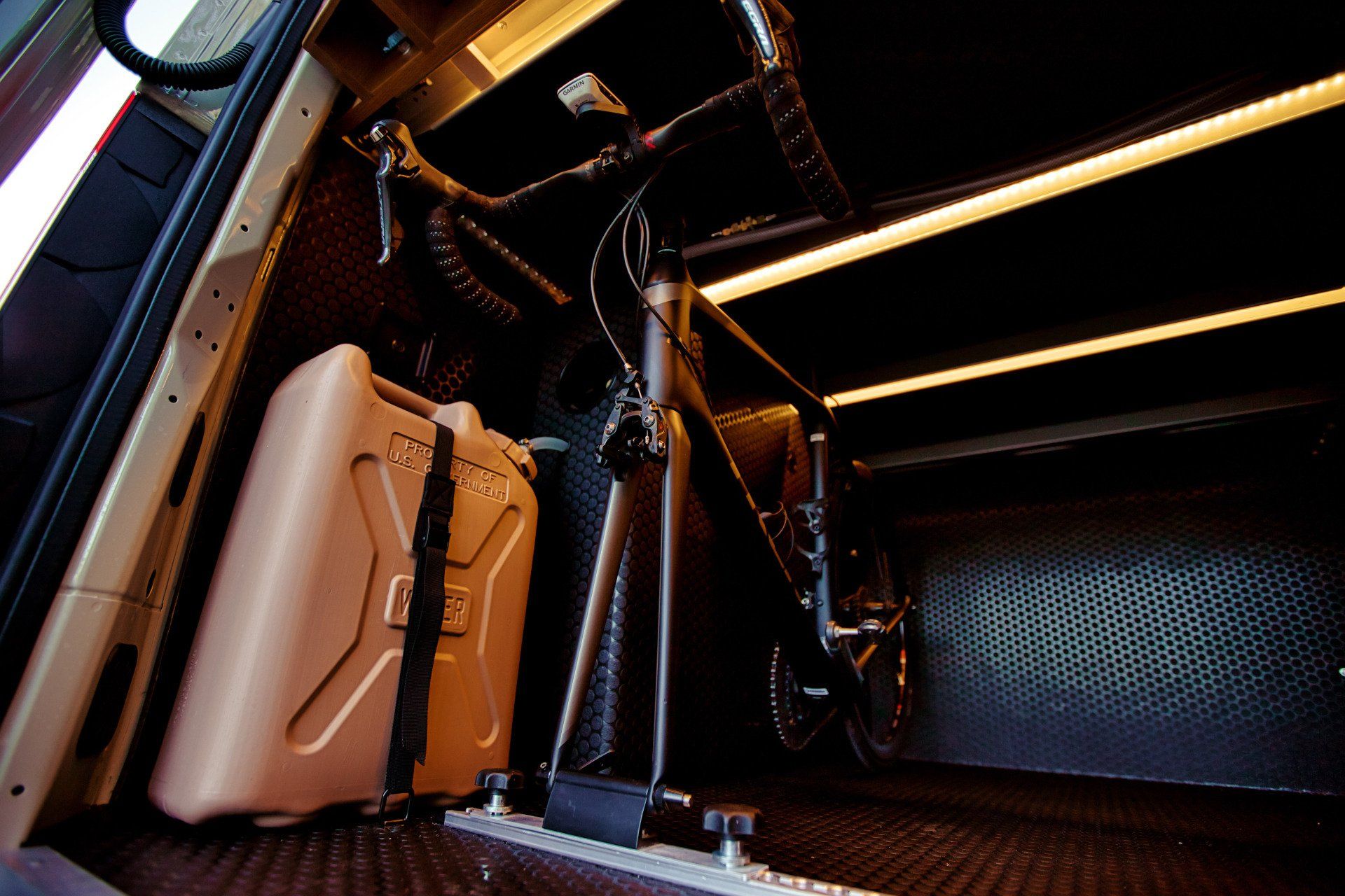 A bicycle is sitting in the trunk of a car