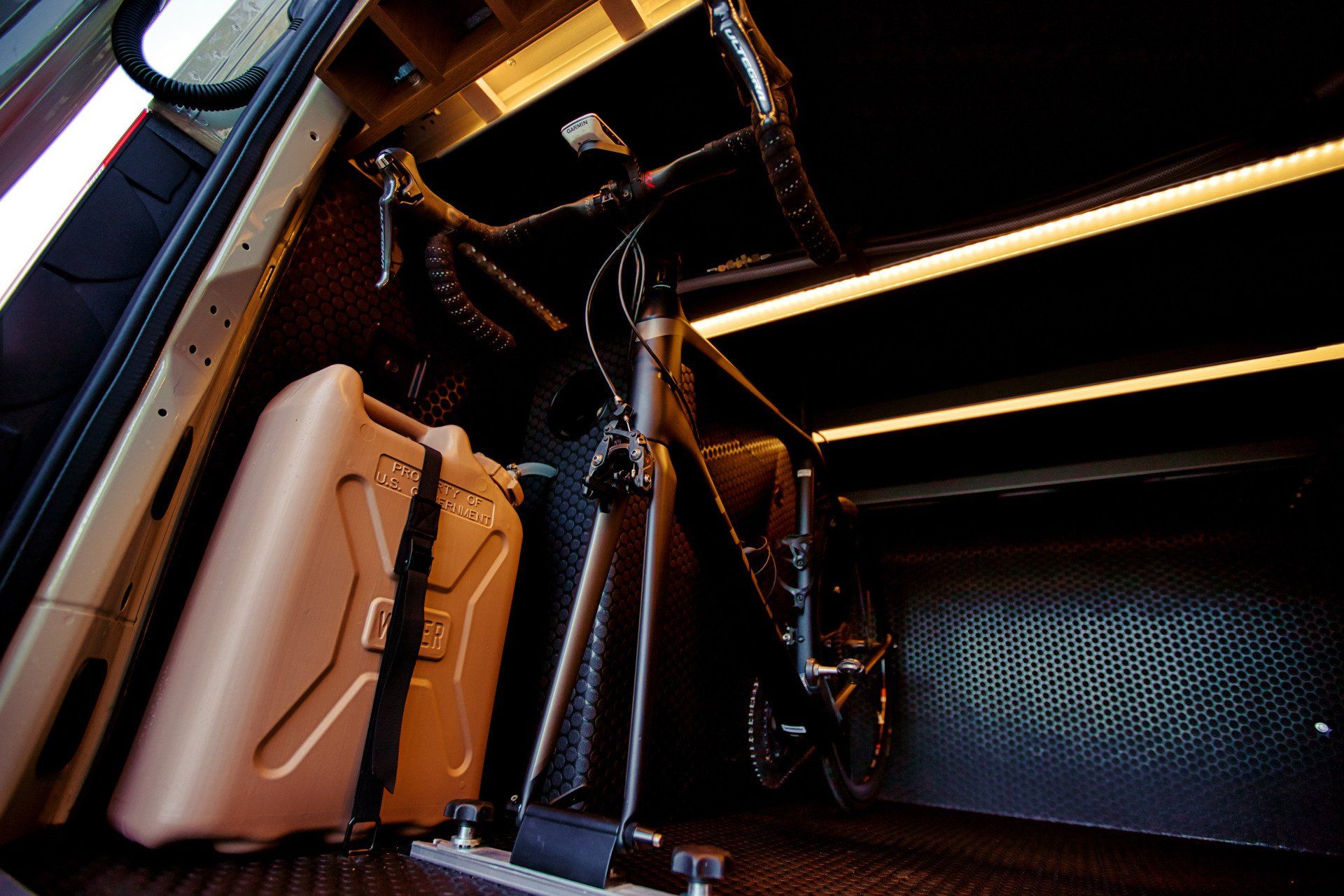 A bicycle is sitting in the back of a car