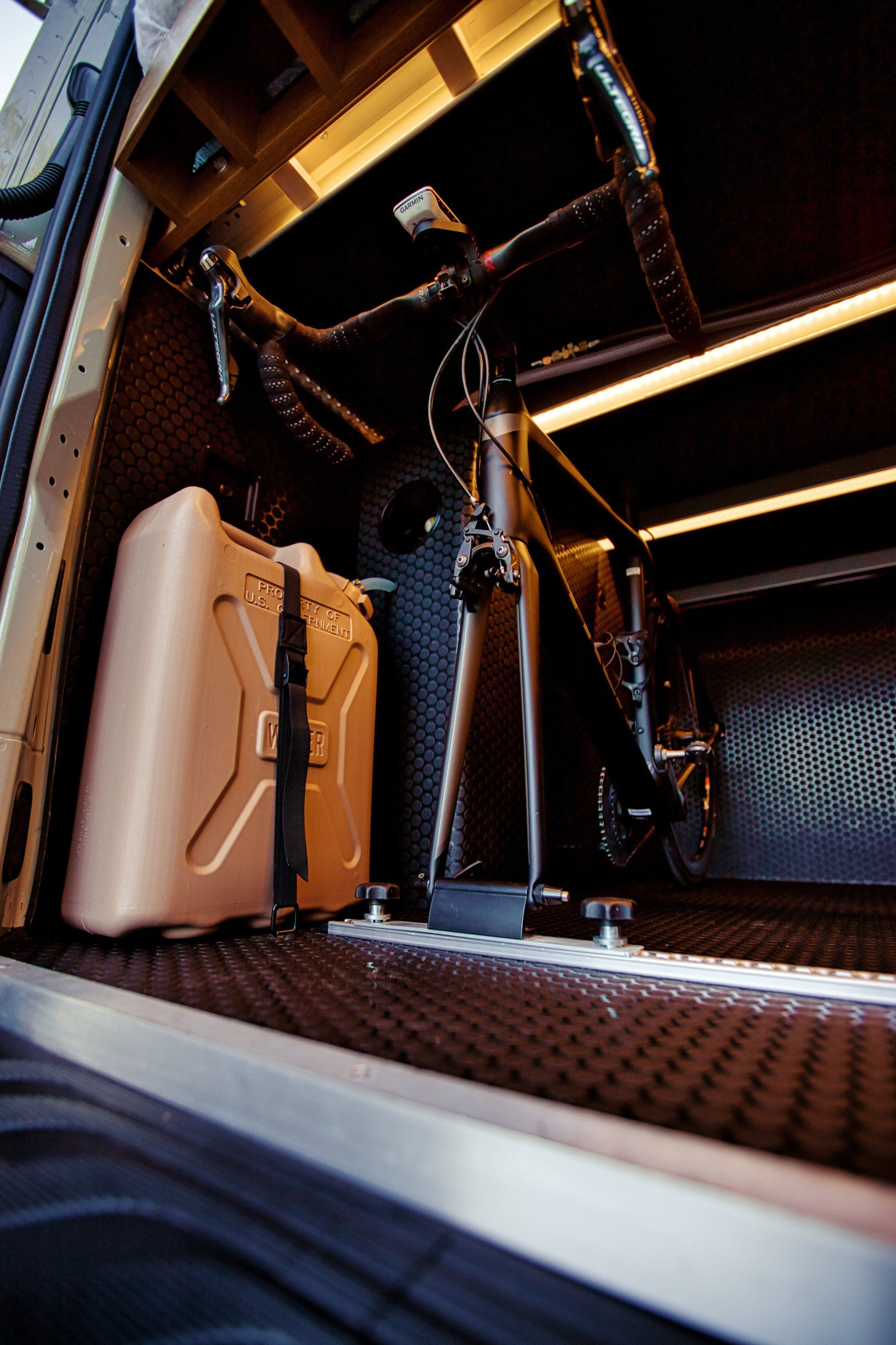 A bicycle is sitting in the back of a truck.