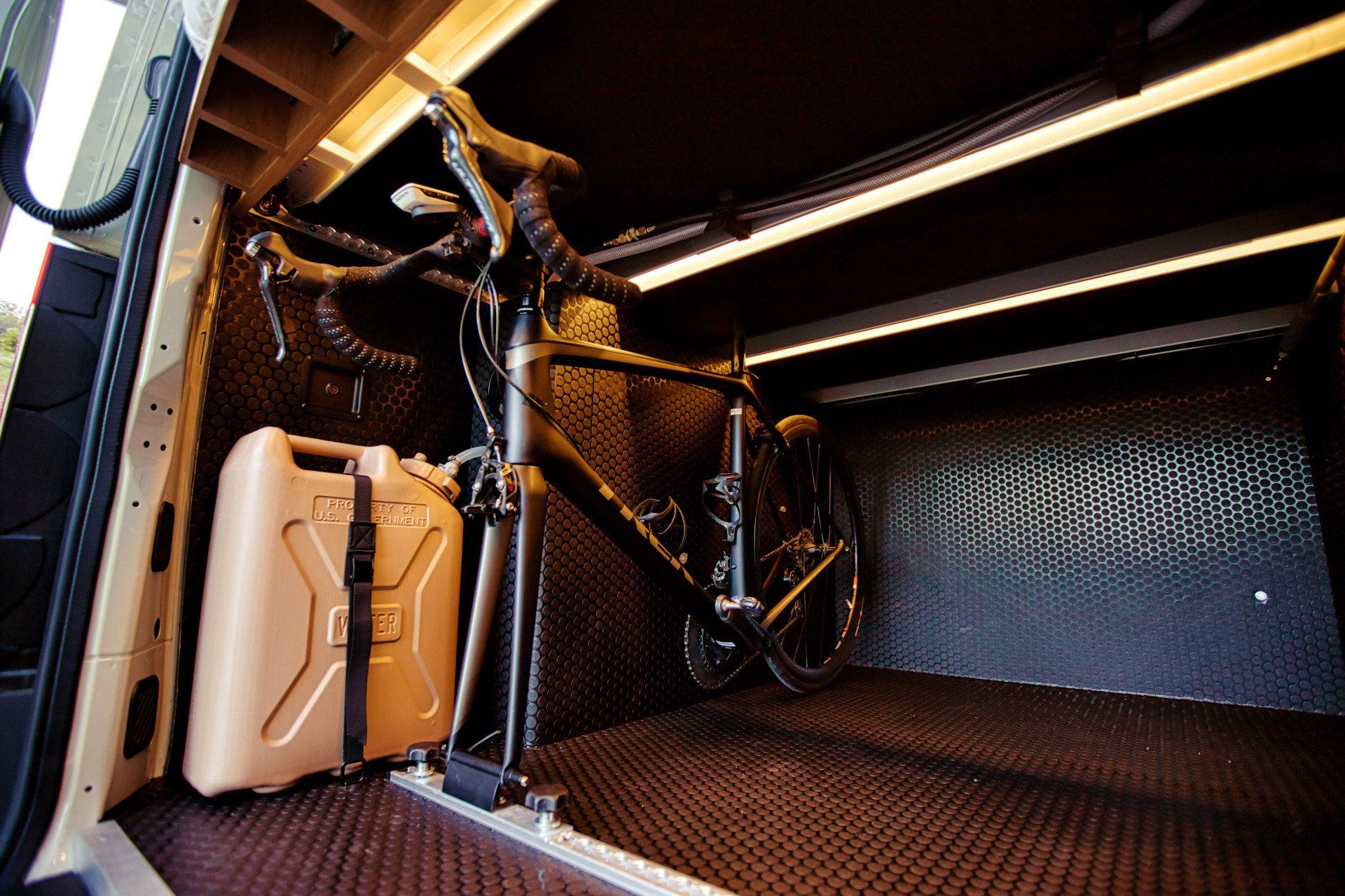 A bicycle is sitting in the back of a van.