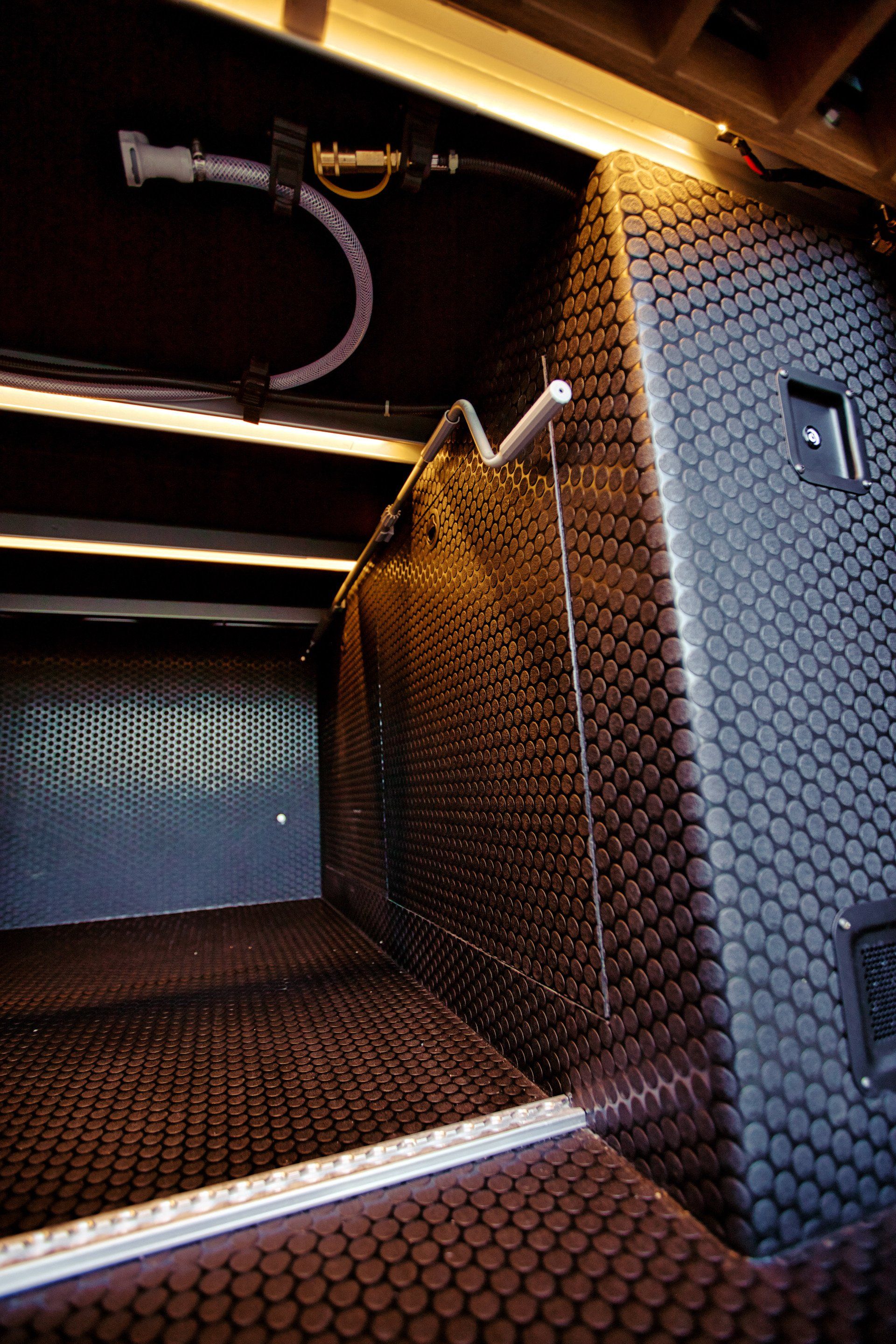 A dark room with a hose hanging from the ceiling