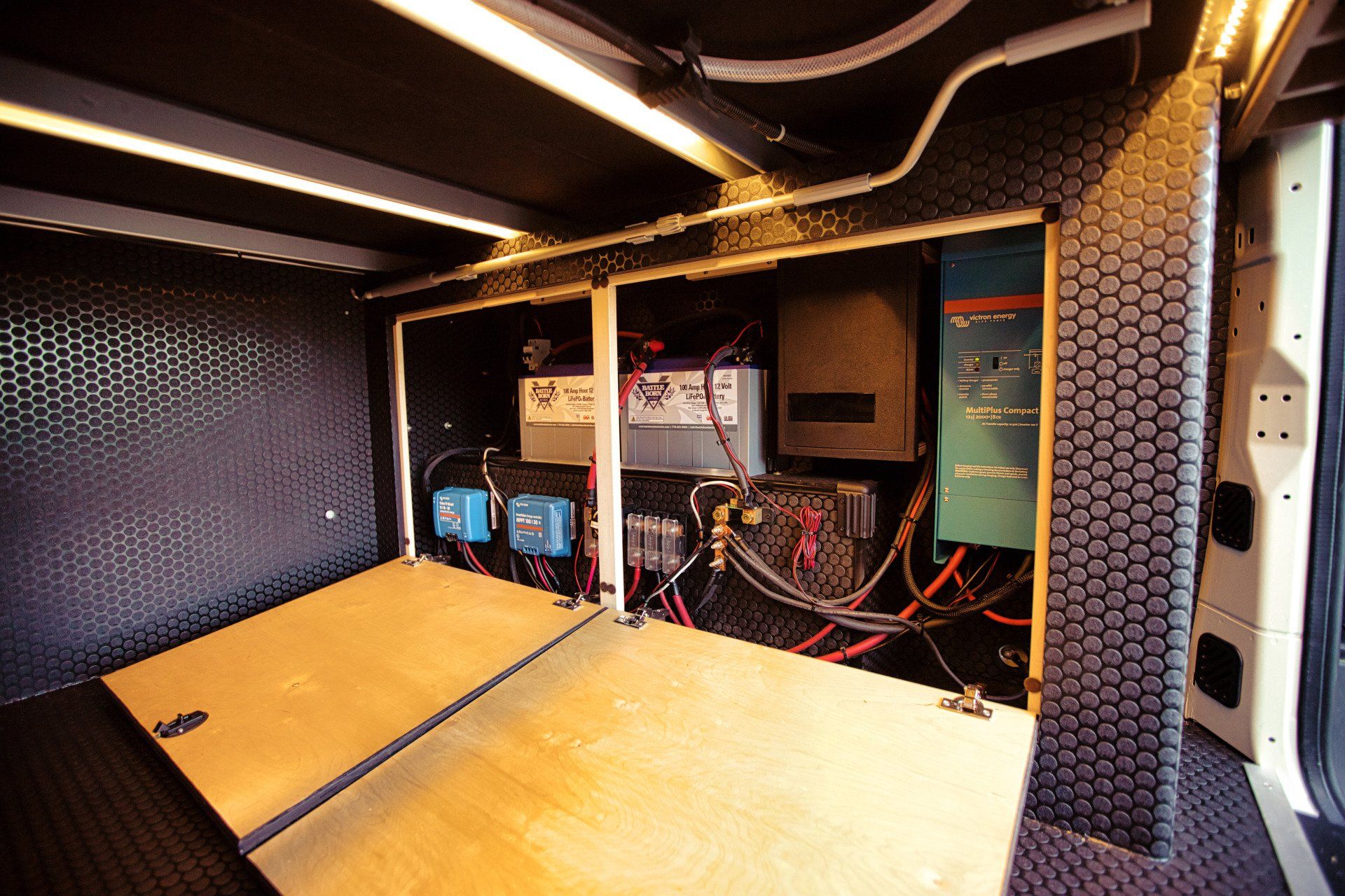 The inside of a van with a lot of electrical equipment.