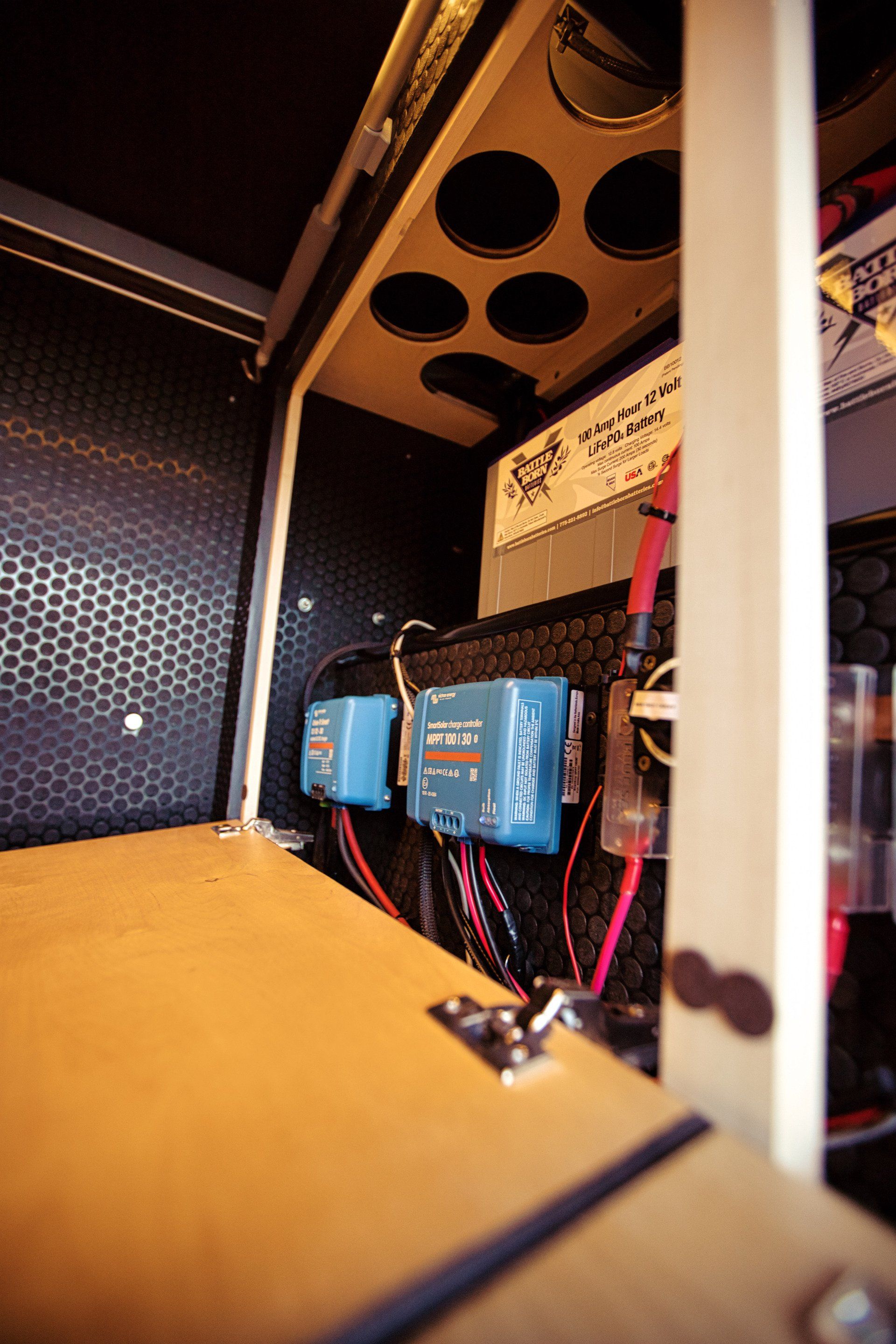 A close up of a box with a lot of wires coming out of it.