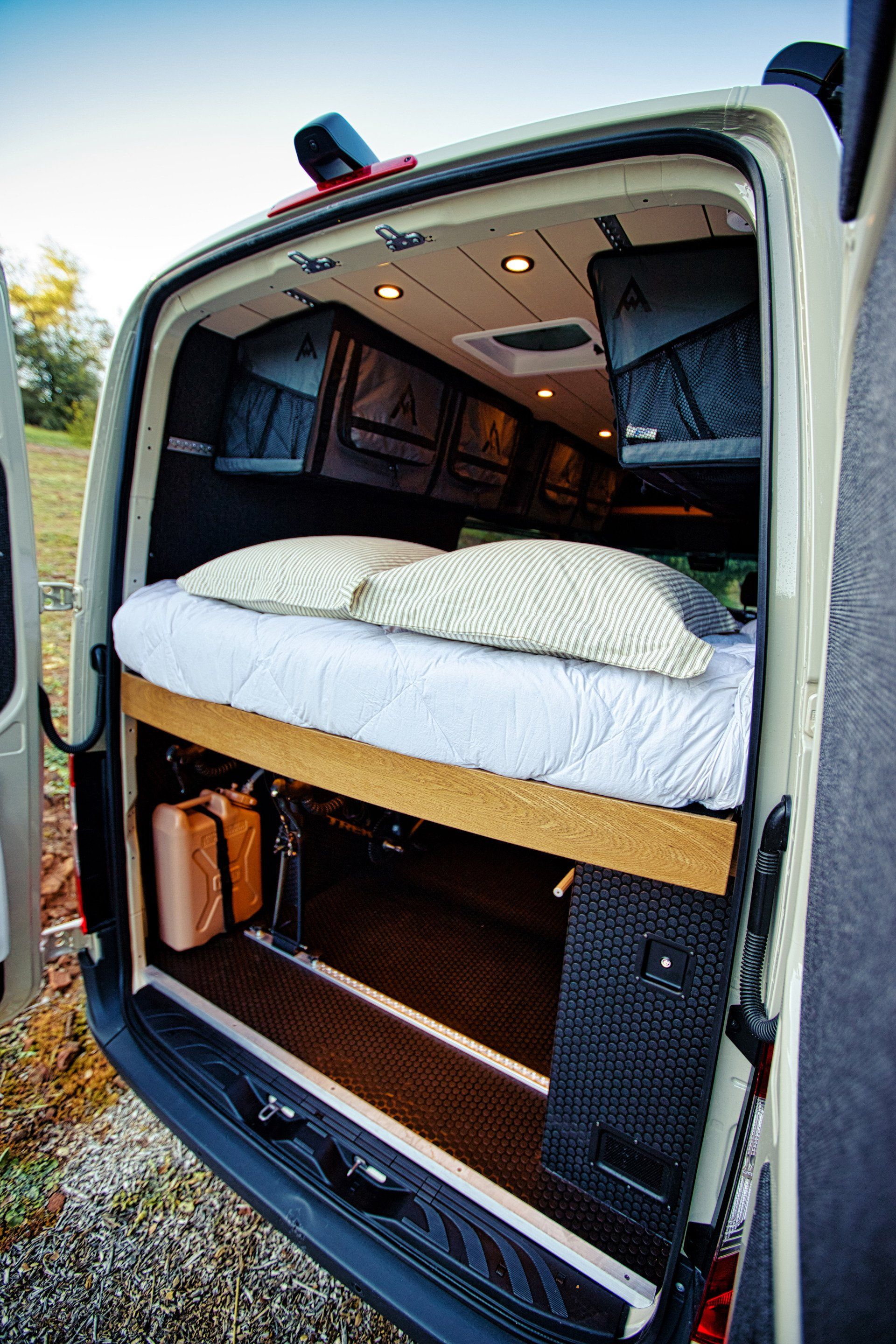 A van with a bed in the back of it.