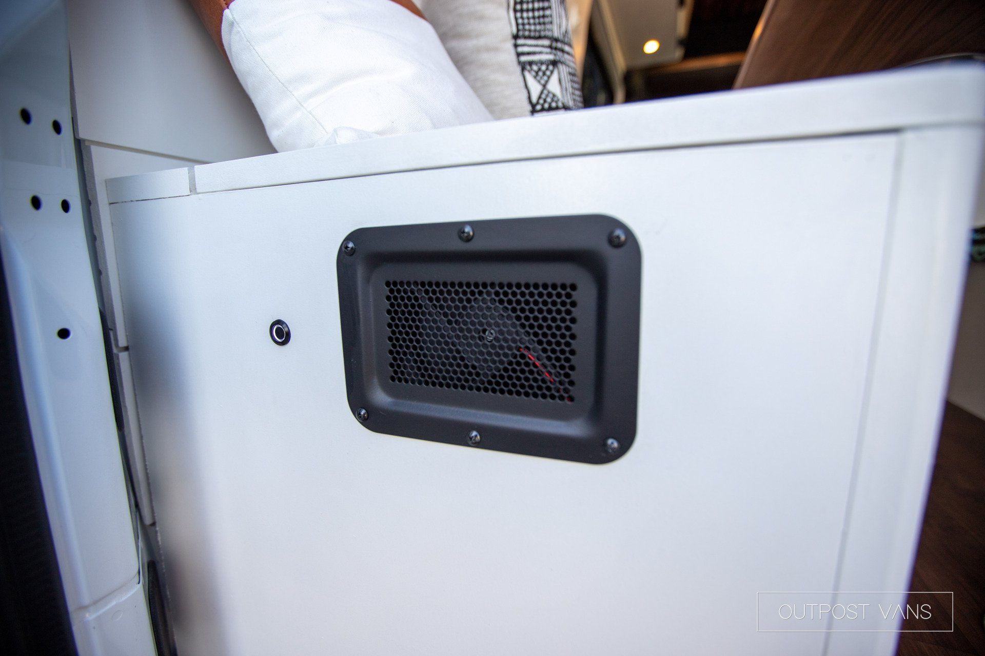 A white box with a fan on the side of it.