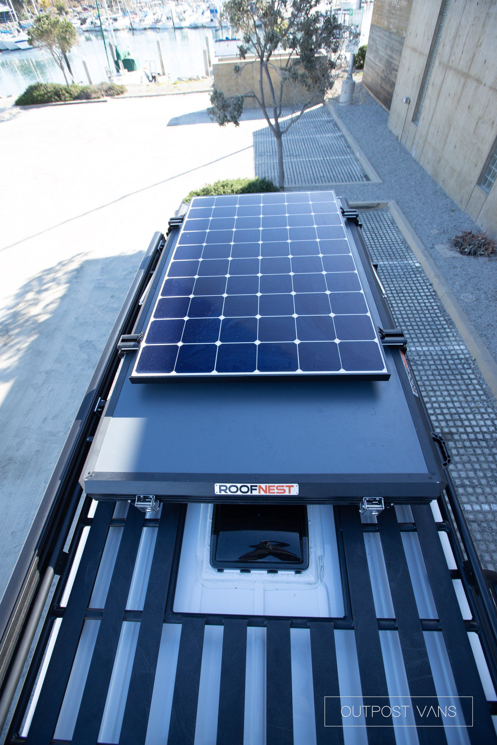 A solar panel is sitting on top of a vehicle