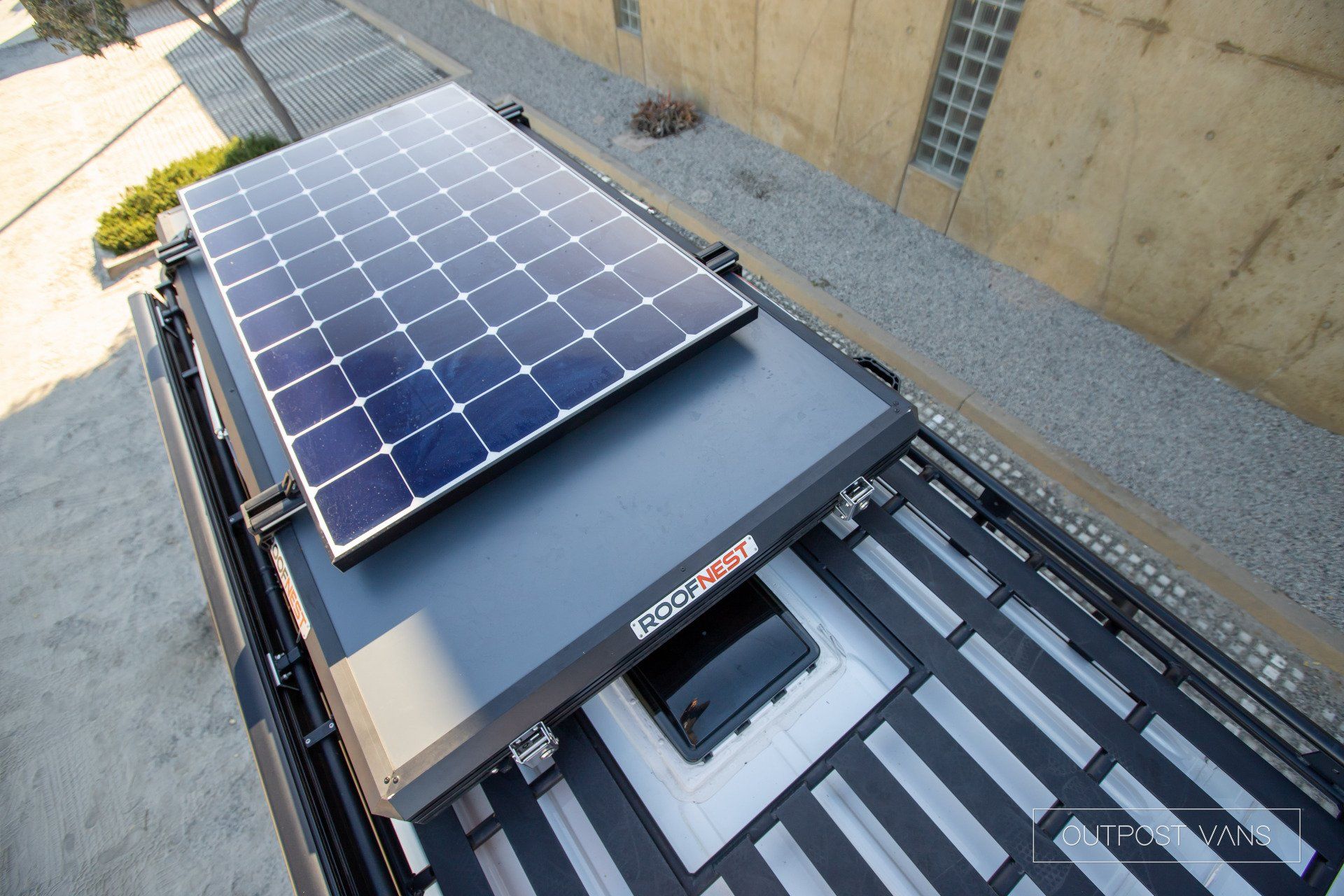 Two solar panels are mounted to the roof of a vehicle